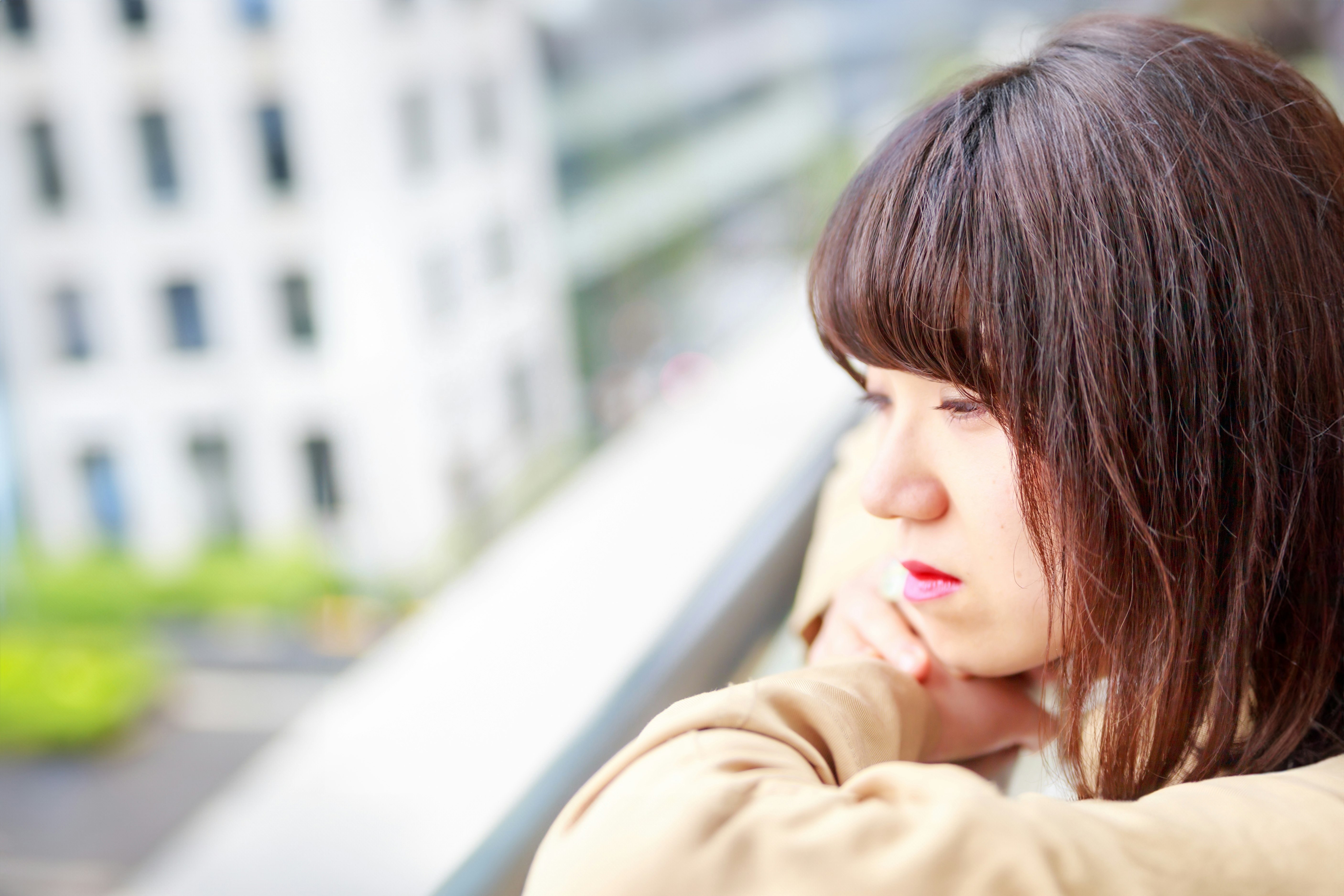 side-profile woman with a city street background