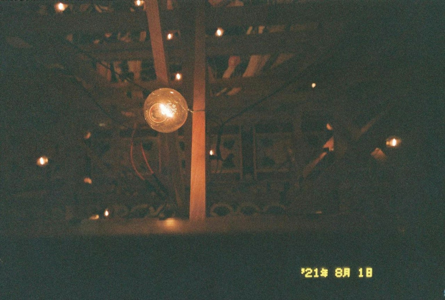 Photo of wooden beams and warm lighting on the ceiling