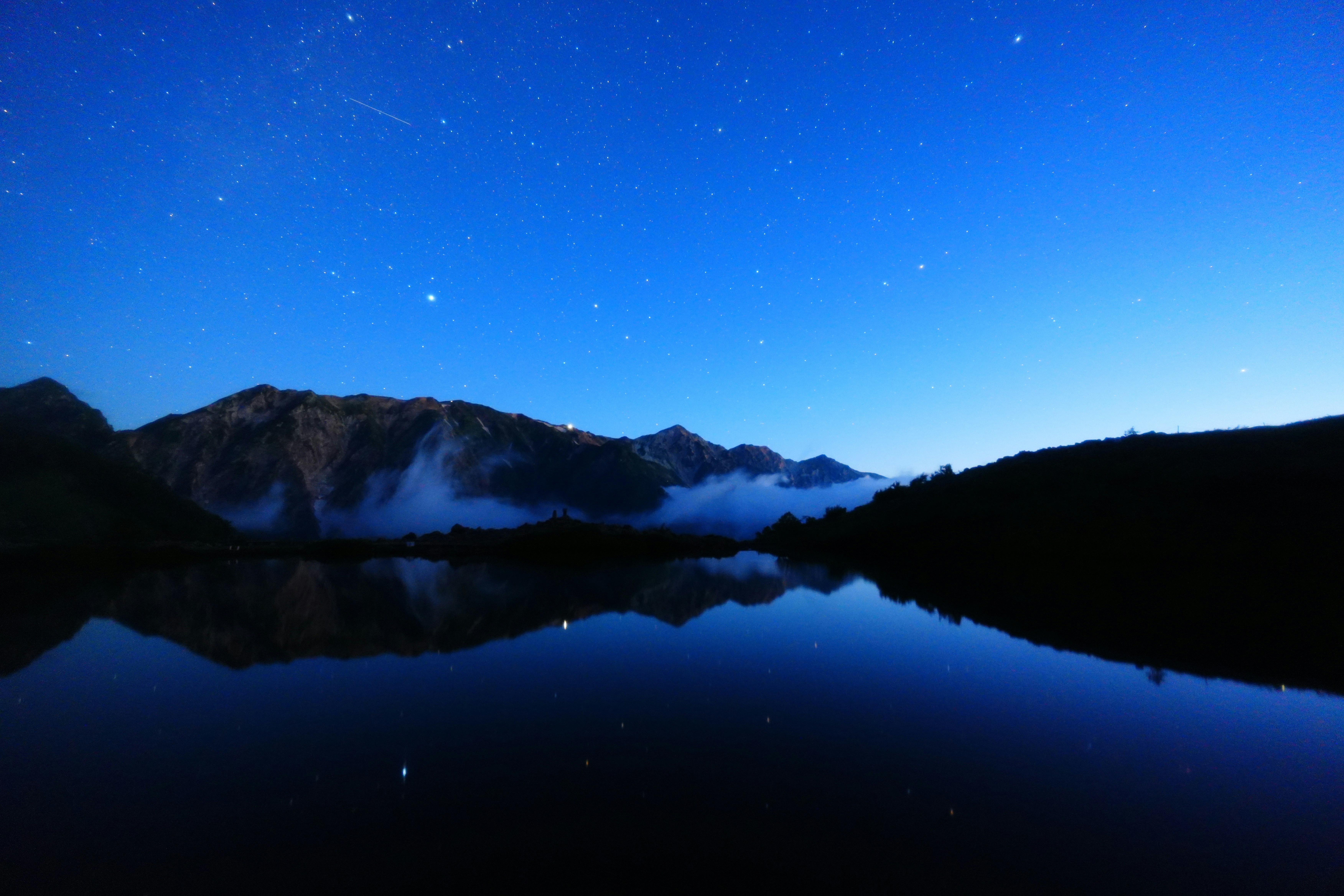 Sternenhimmel über dem Happo-Teich bei der Dämmerung, Spiegelungen der Nordalpen