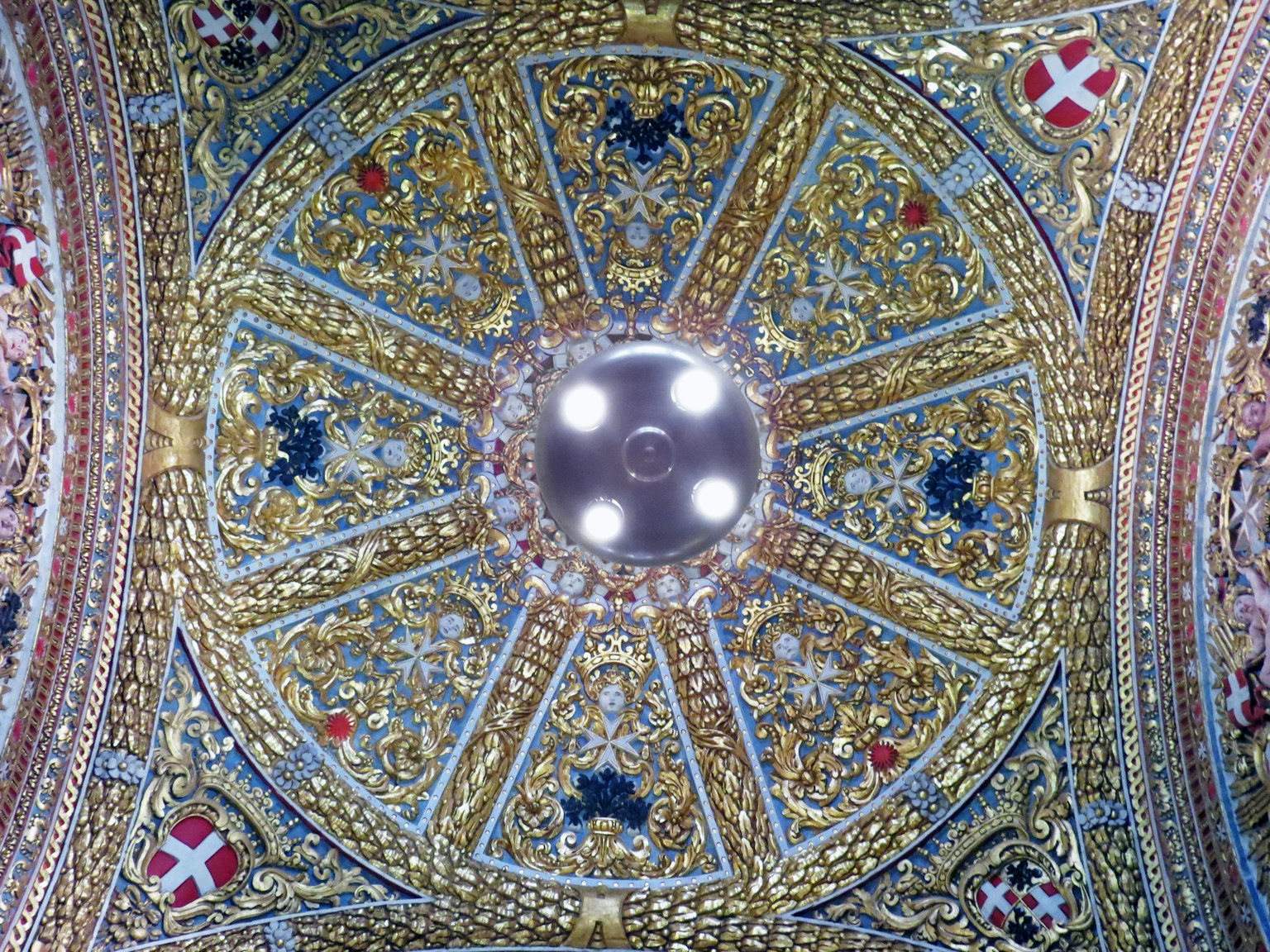Intricate golden and blue ceiling design with ornate decorations