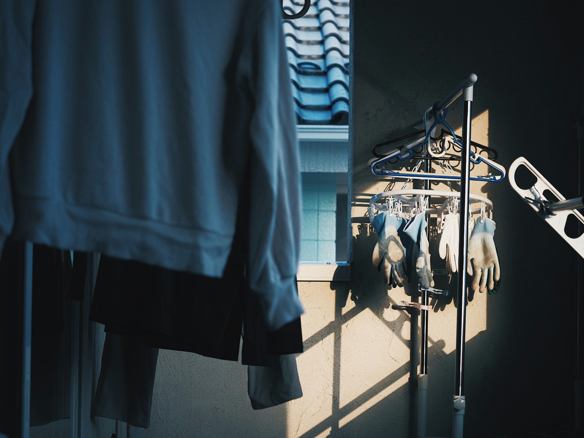 Clothes hanging on a balcony clothesline at dusk