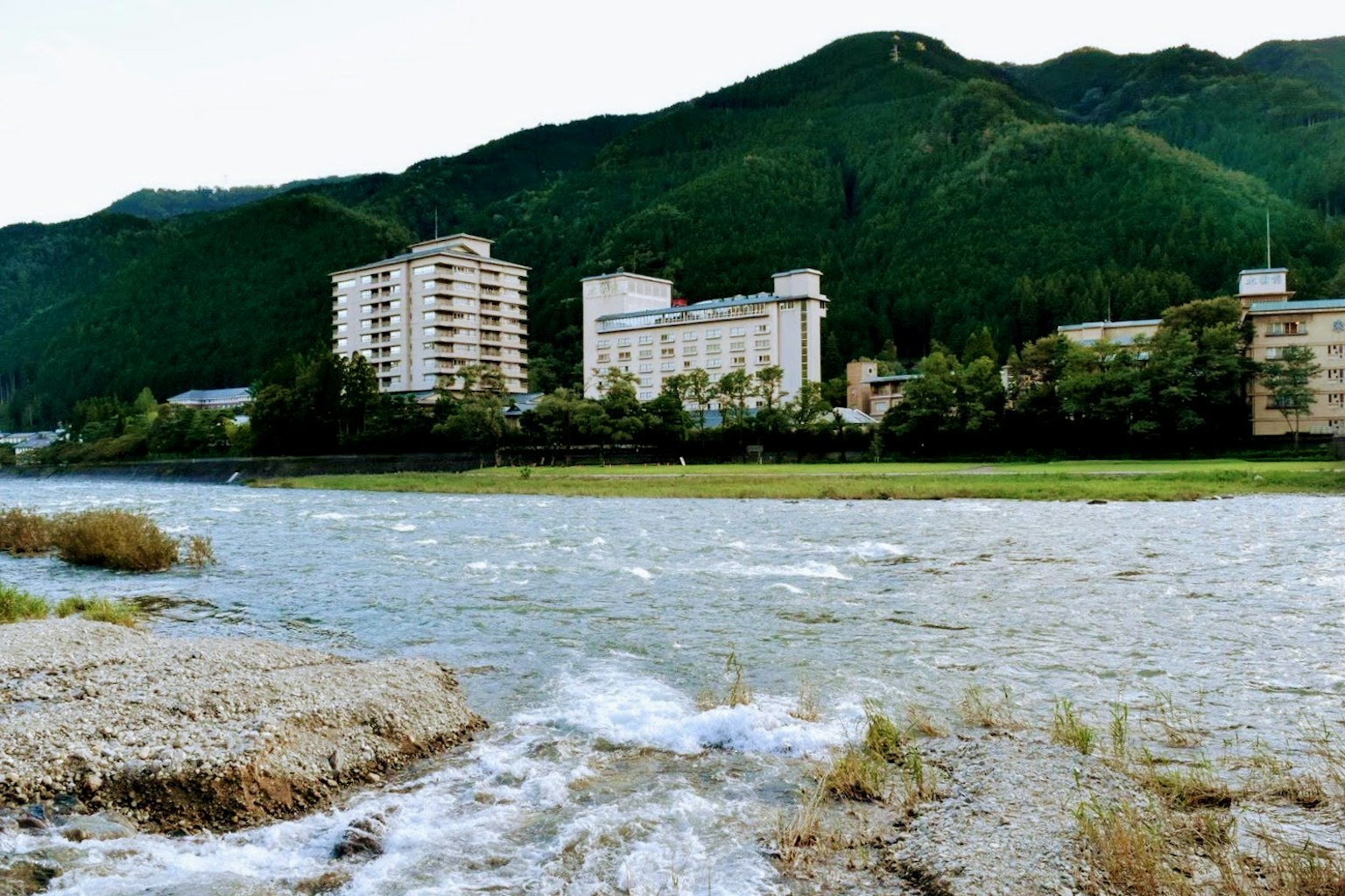 沿河建築的風景，背景是山脈