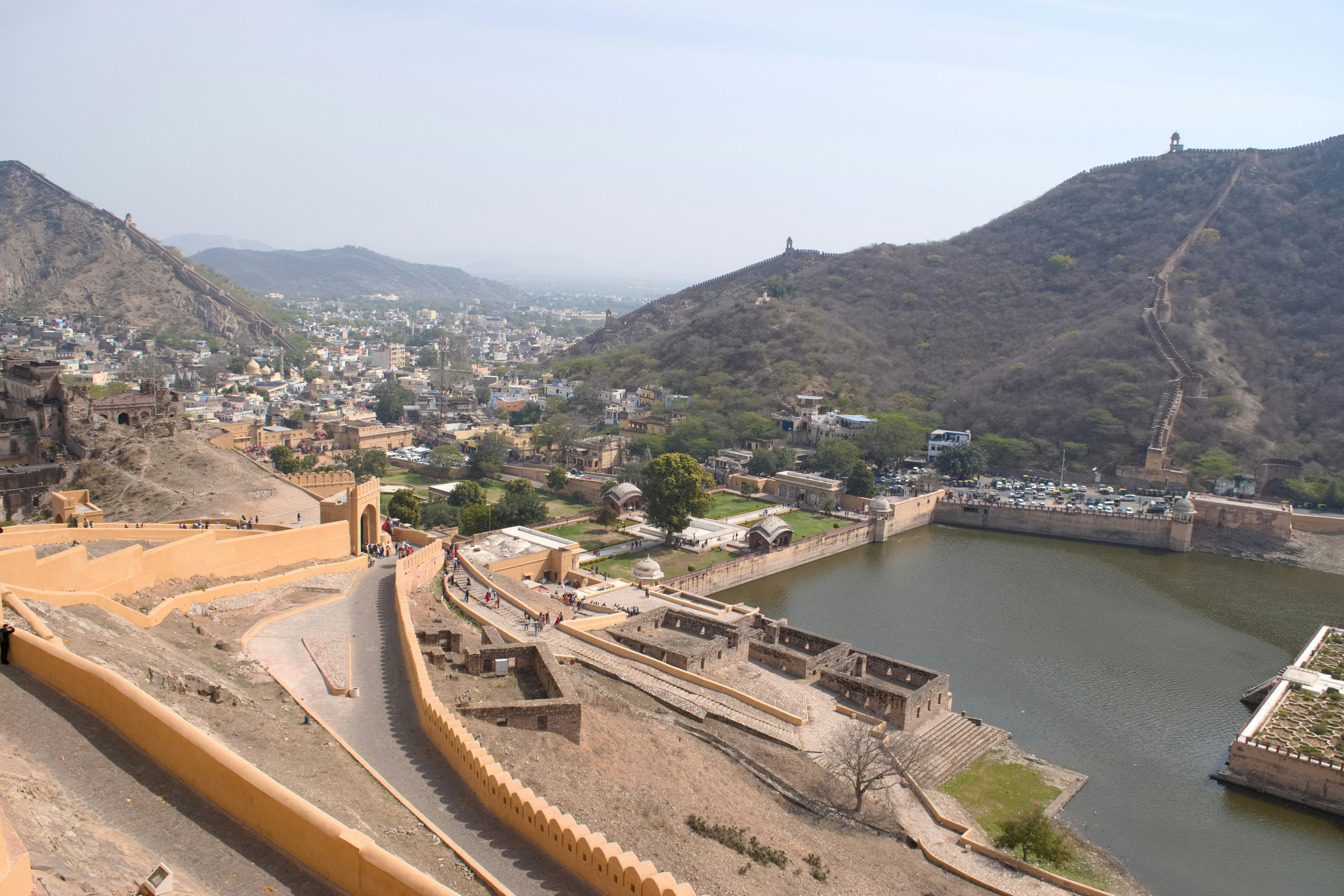 aerial view of a riverside fortress and town nestled in mountains