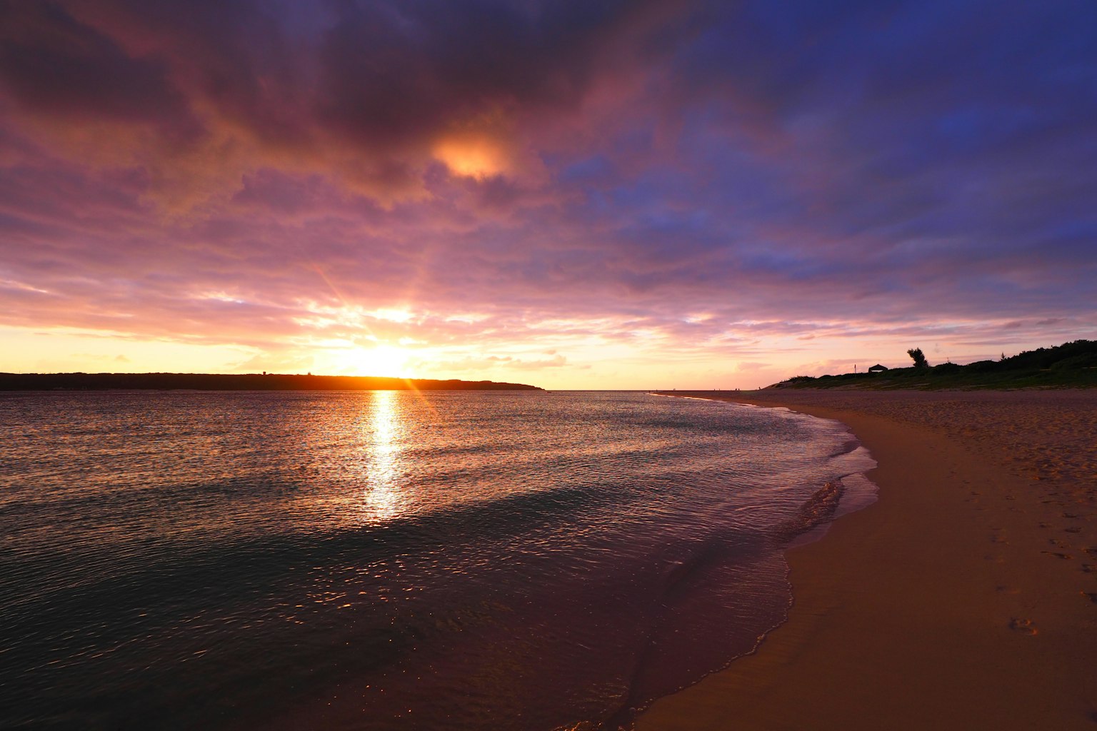 Beautiful sunset over the ocean with vibrant purple and orange sky