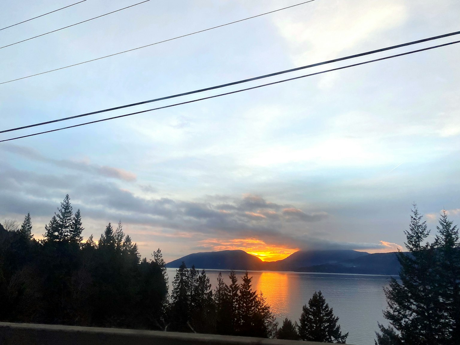 Beautiful sunset reflecting on the lake surrounded by trees