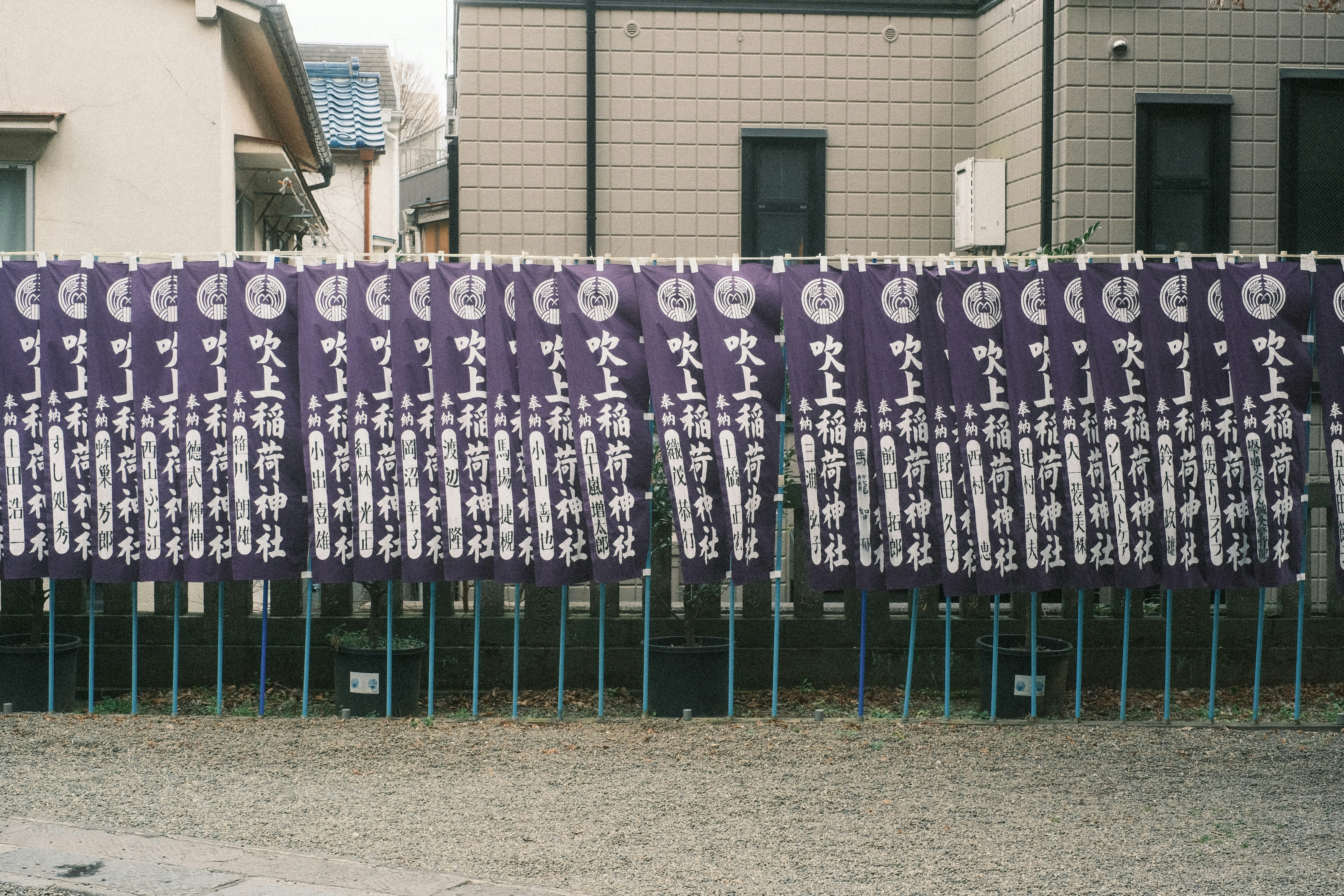 Rows of memorial prayer plaques along a wall