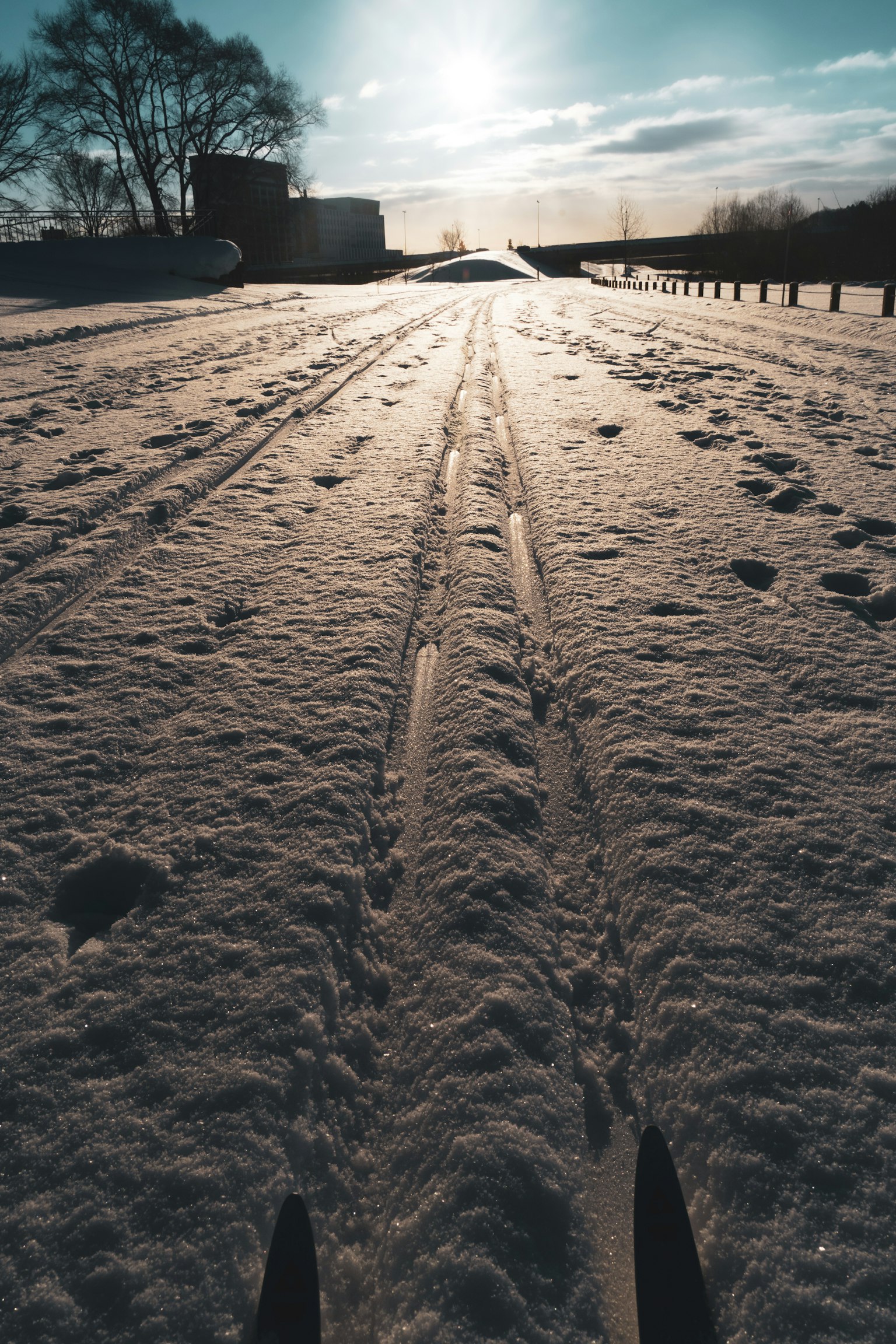 Ski tracks on snow with a winter landscape