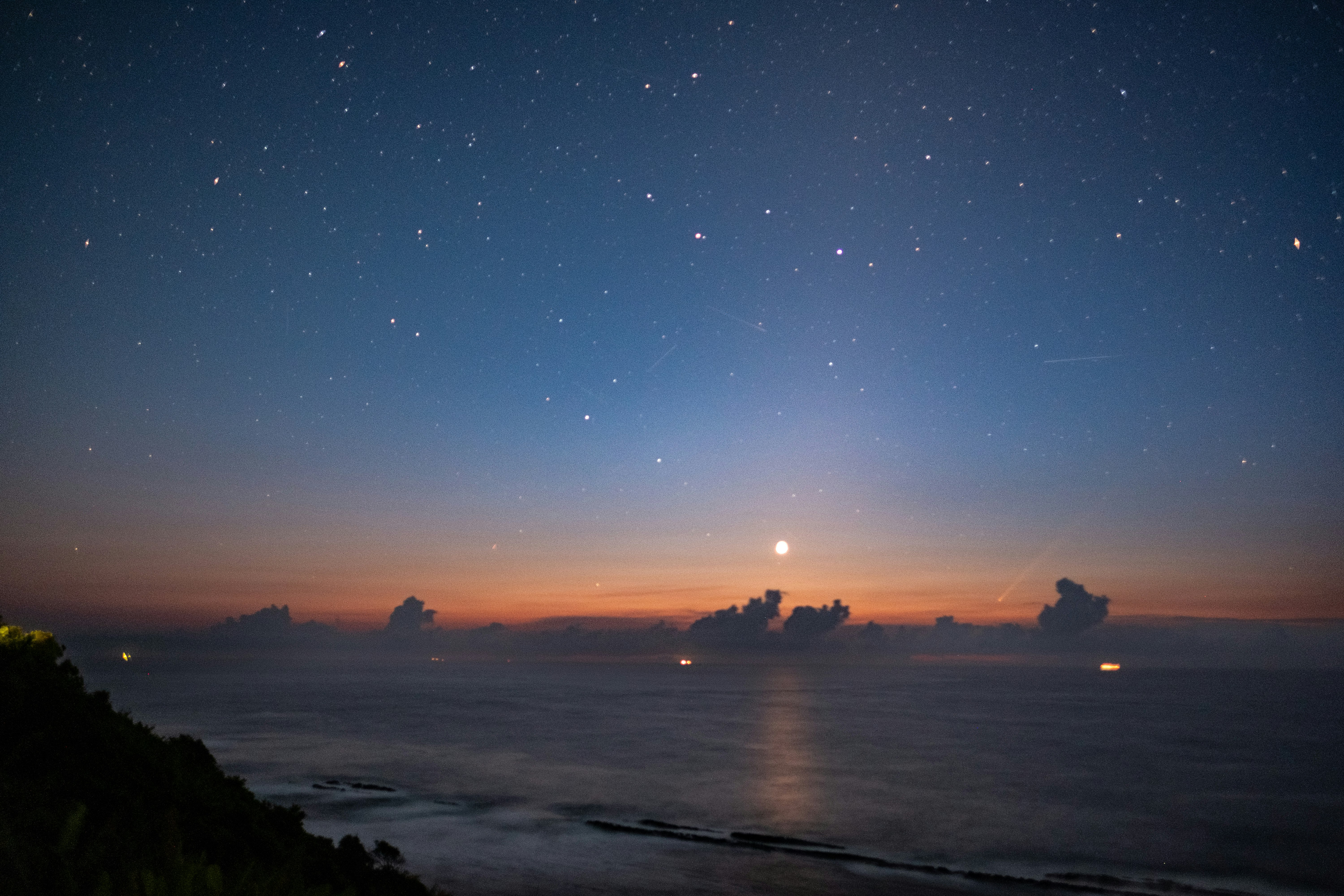 dawn over the ocean with a starry sky
