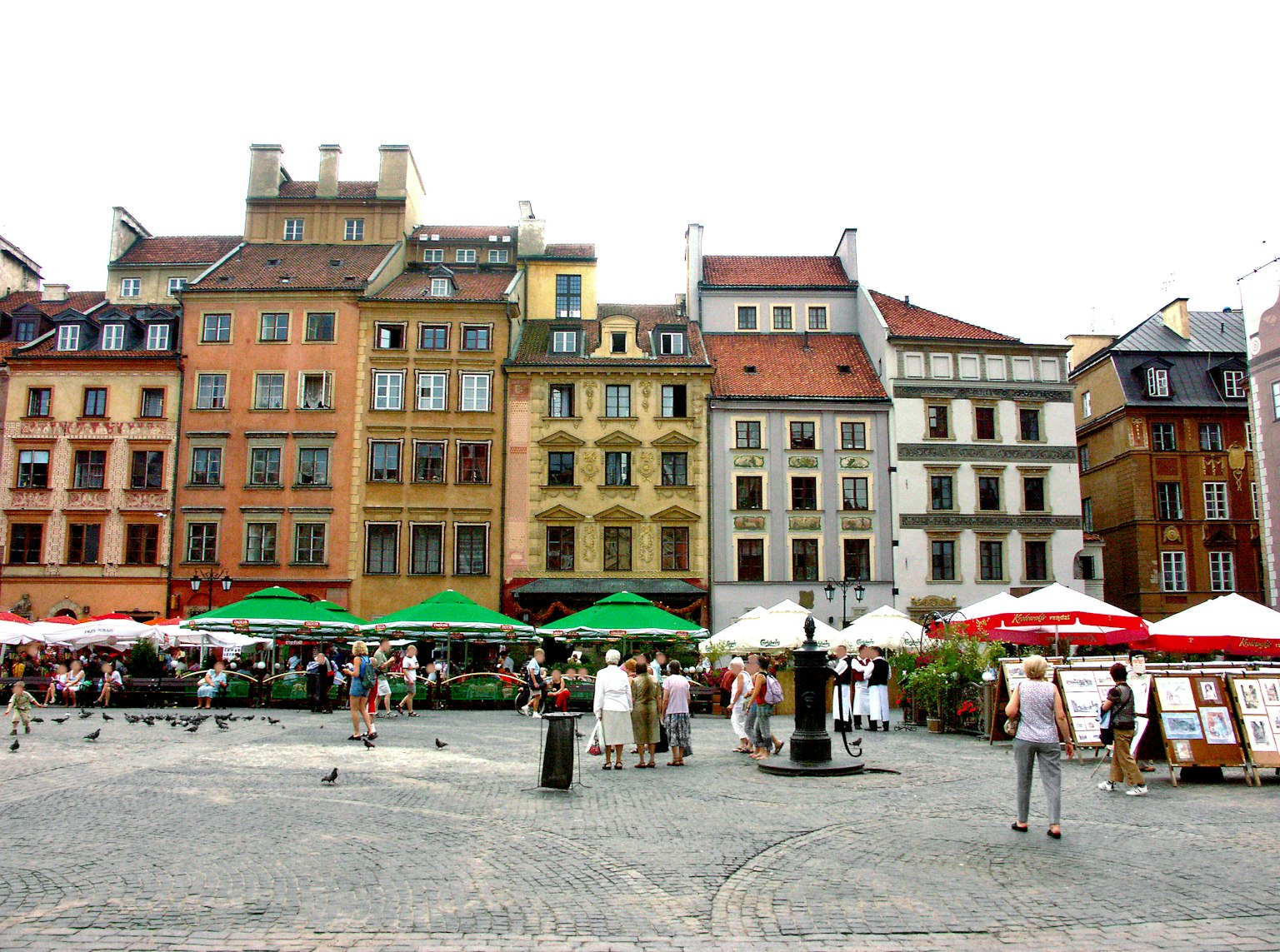 Colorful buildings line a square where people gather