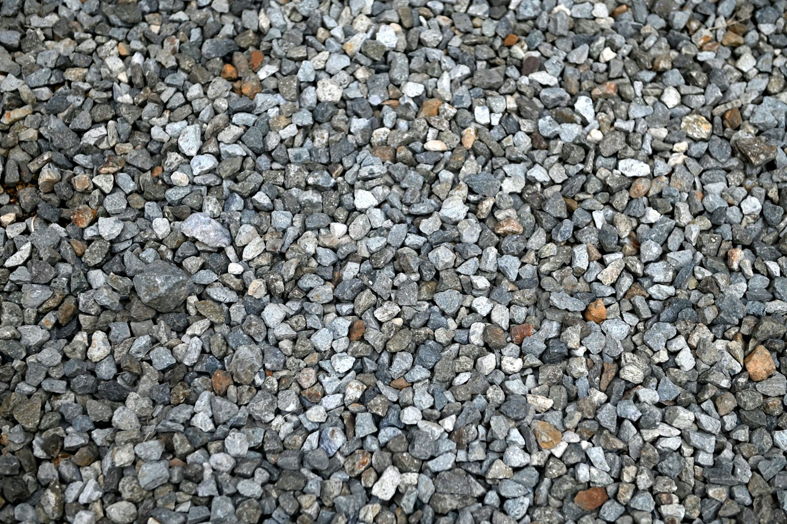 A collection of small stones displaying various shades of gray
