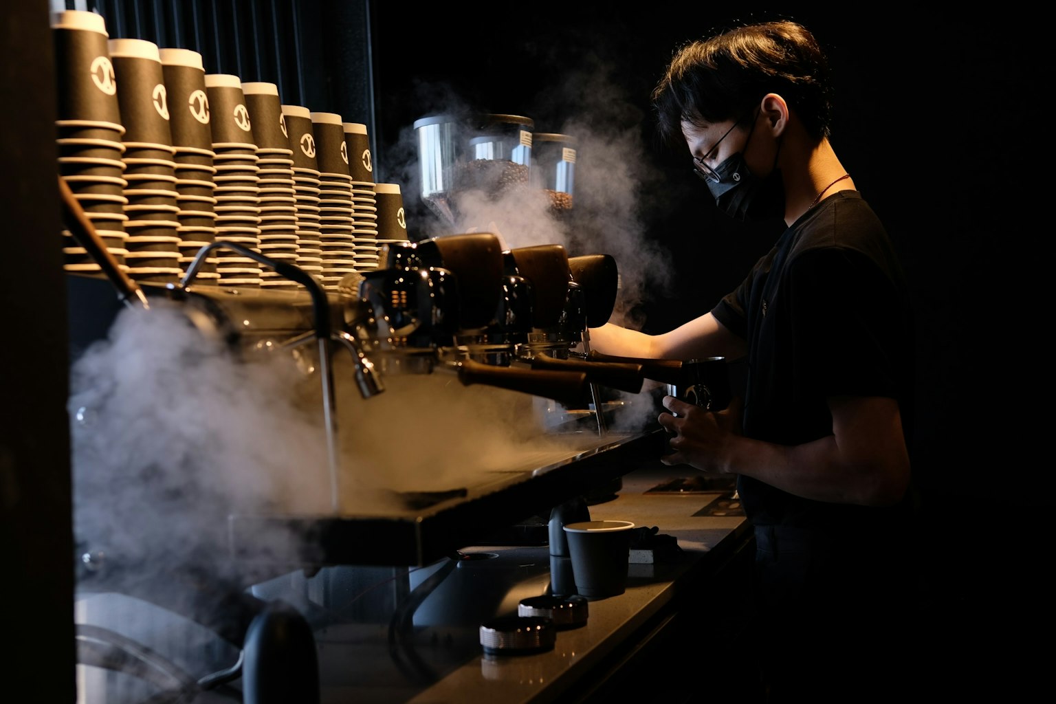 Un barista che estrae caffè da una macchina per espresso in un caffè