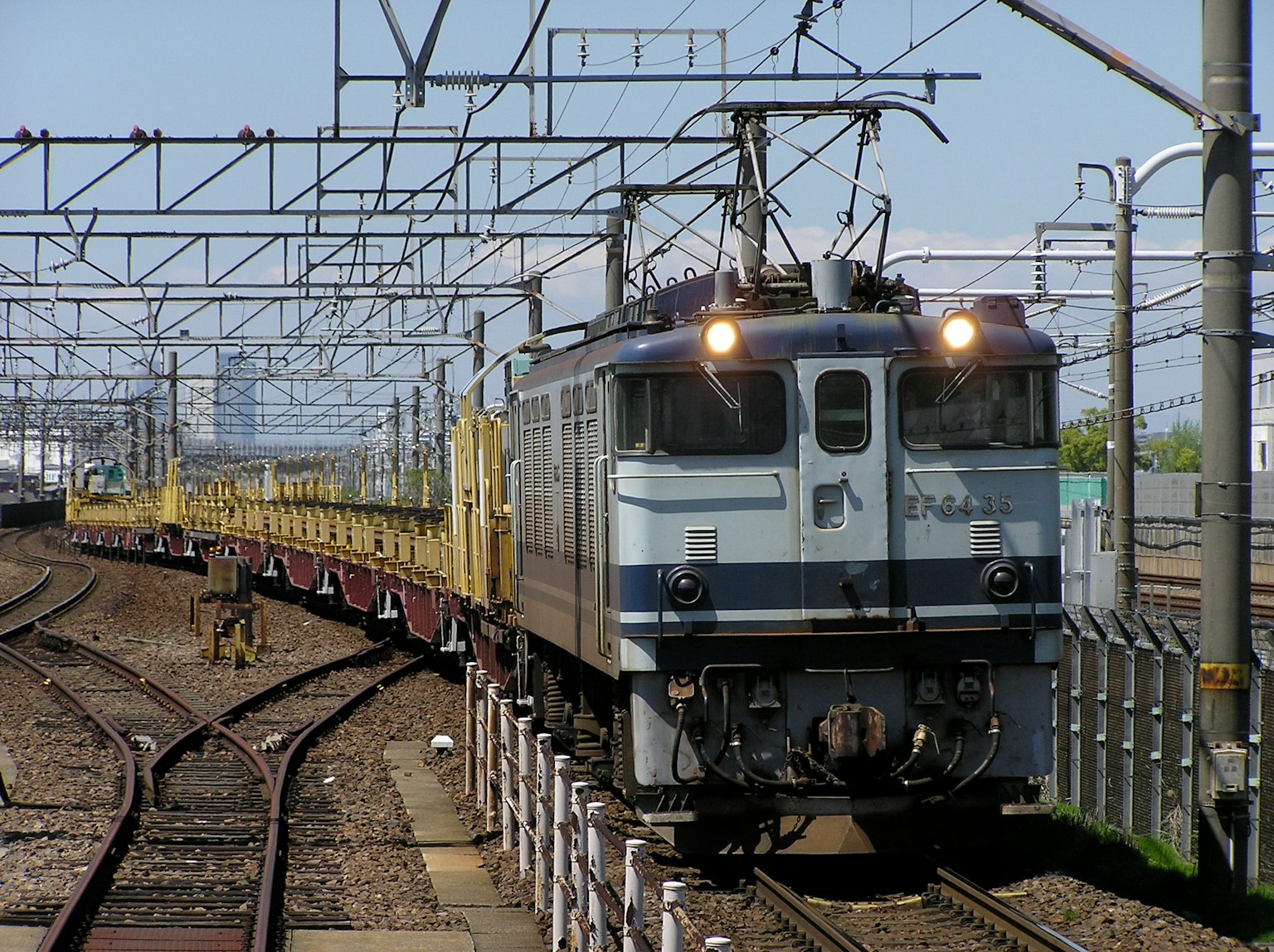 Electric locomotive pulling a freight train along the tracks
