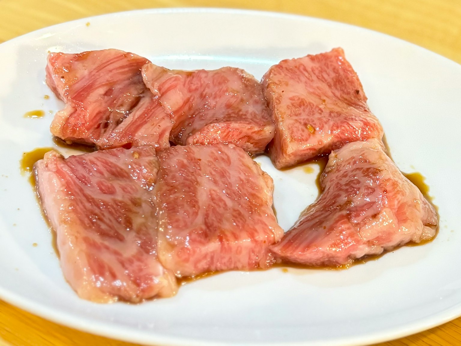 Sliced pieces of meat arranged on a white plate