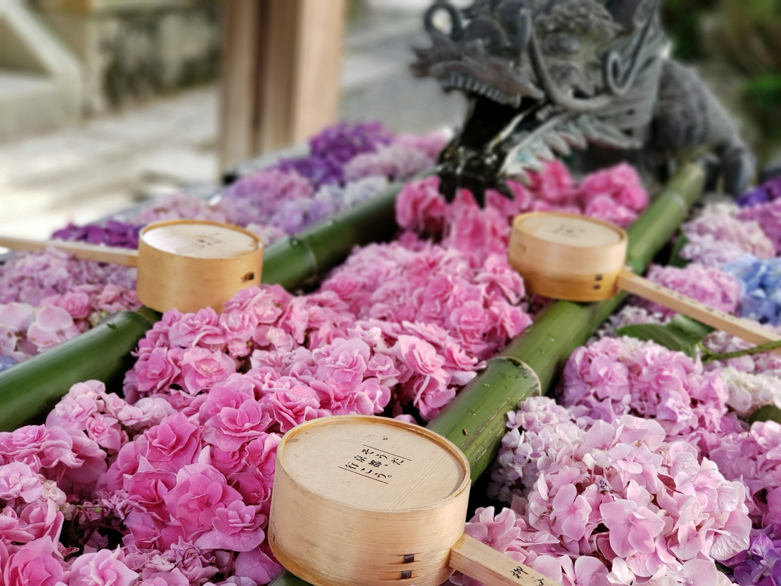 Close-up of a decorative altar adorned with colorful flowers bamboo sticks and wooden containers
