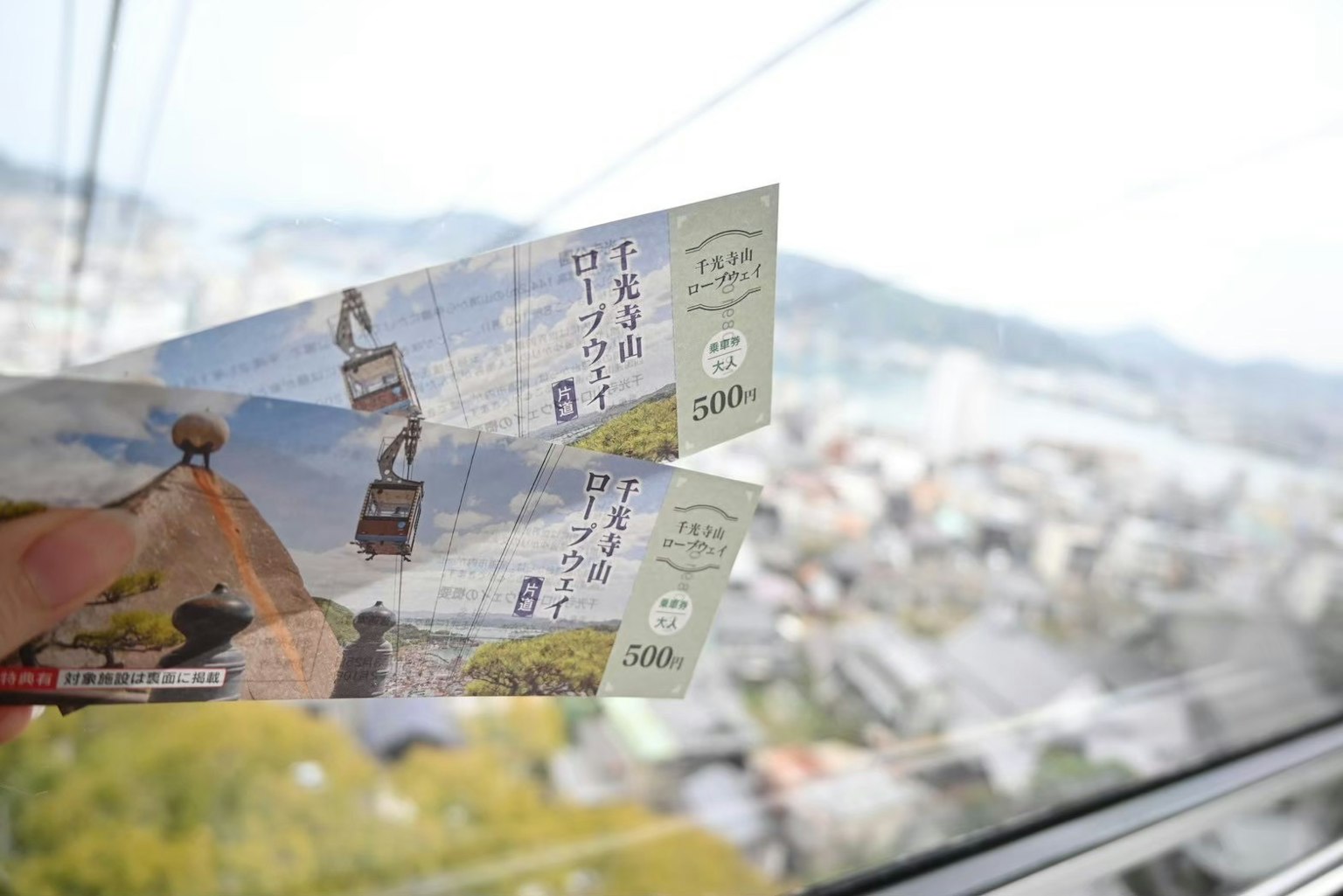 Ropeway tickets with mountain scenery in the background