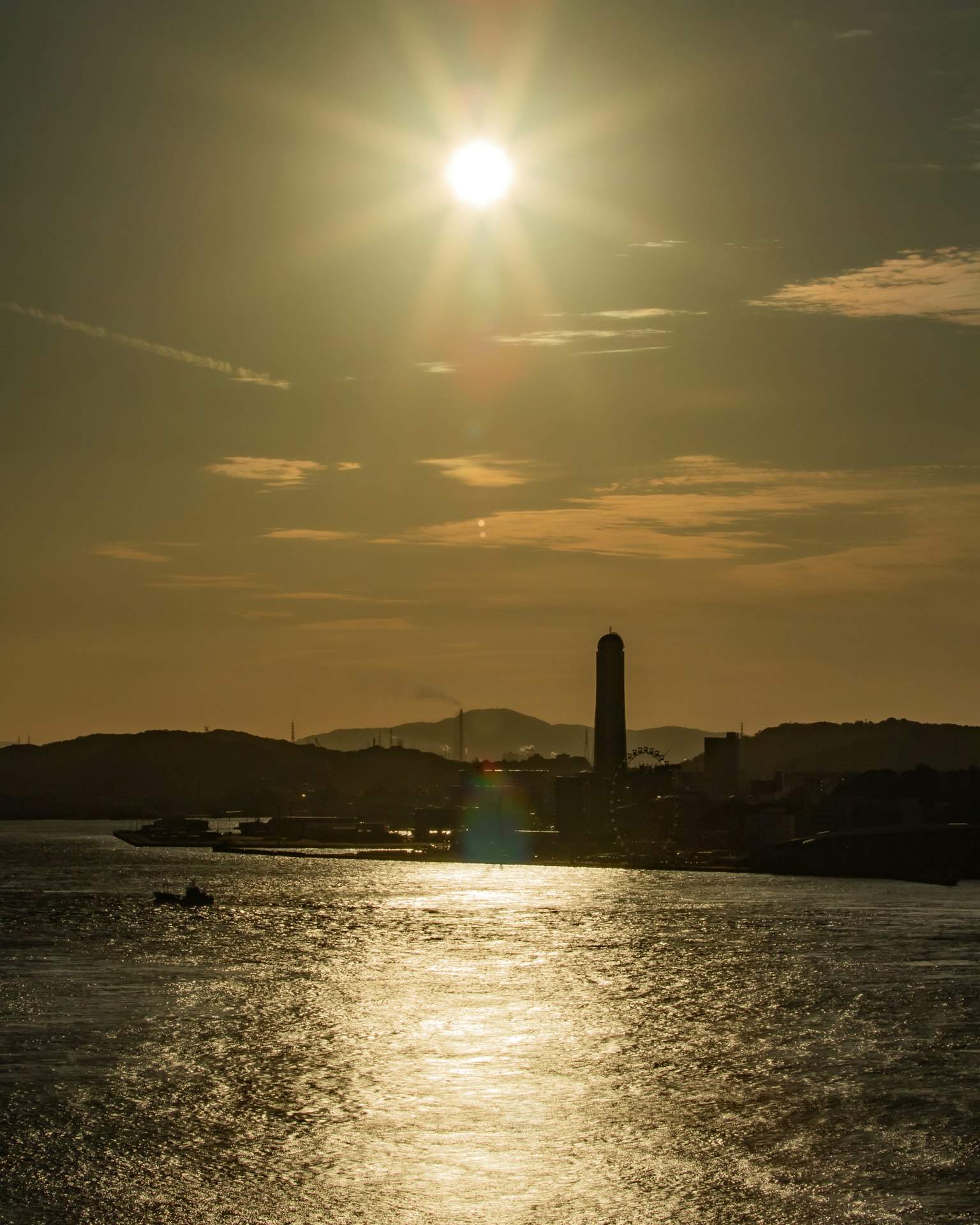 Sunset reflecting on the water with a silhouetted tower