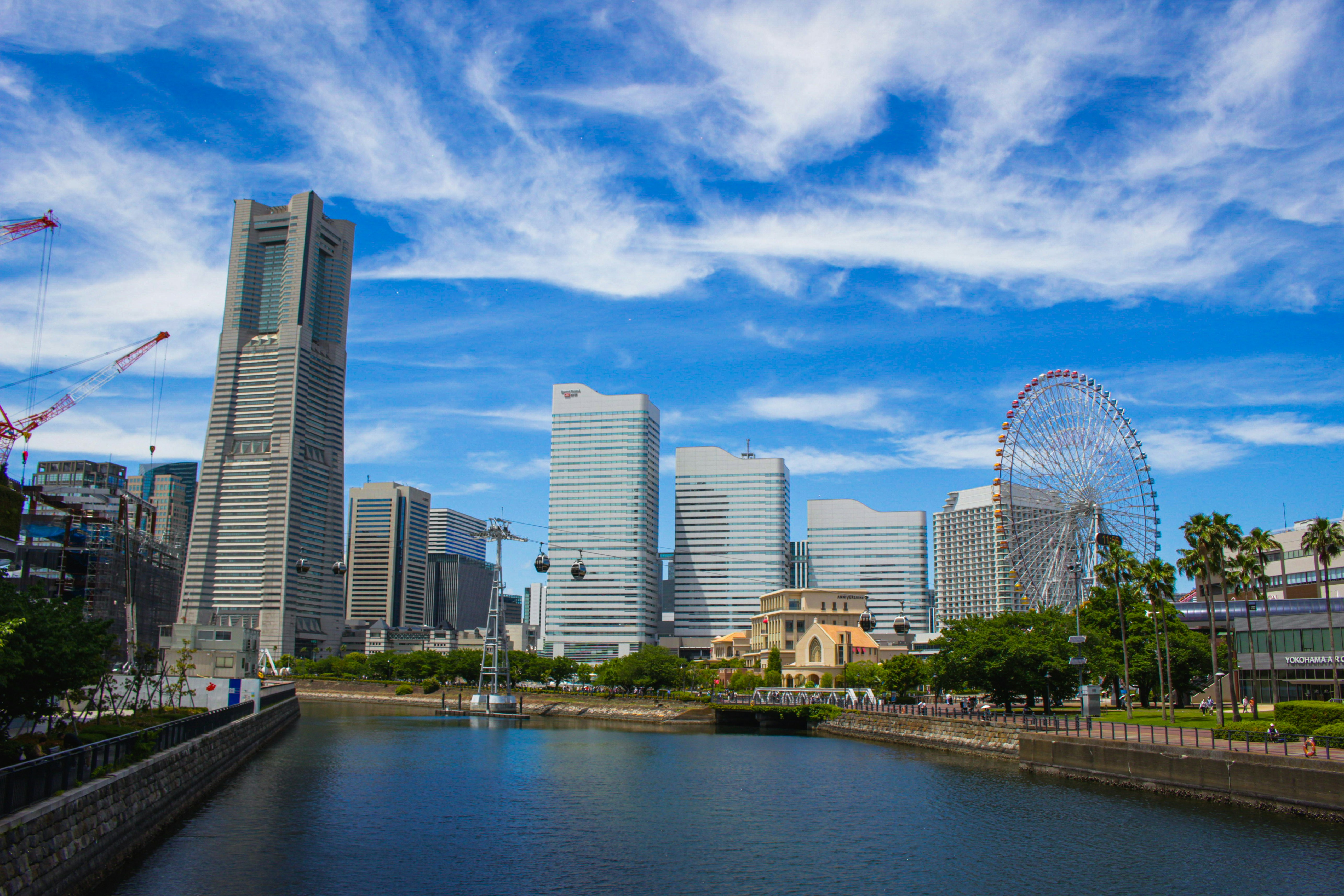 Yokohama skyline along a canal under a blue sky