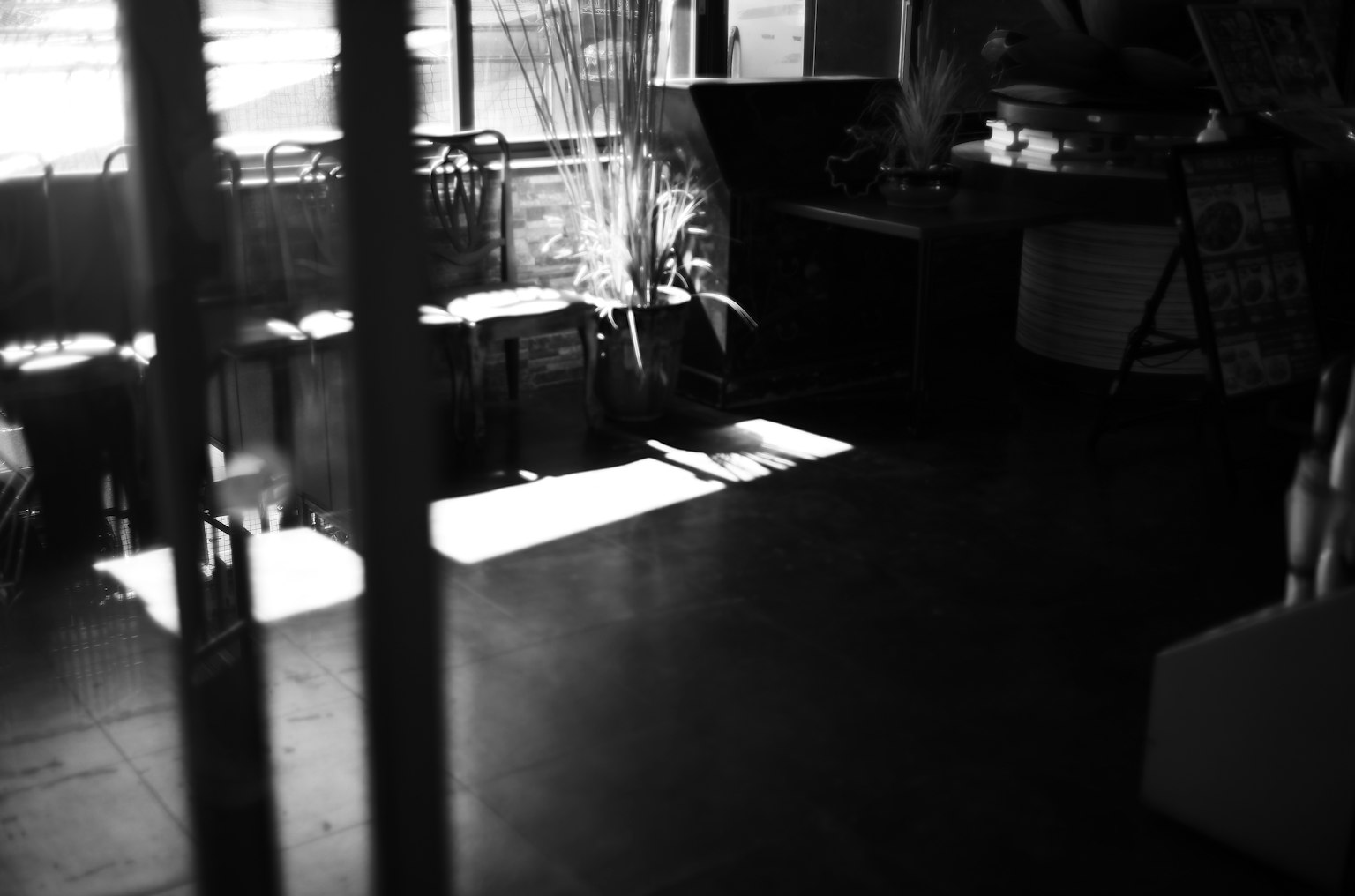 Dim indoor space with striking light and shadow patterns
