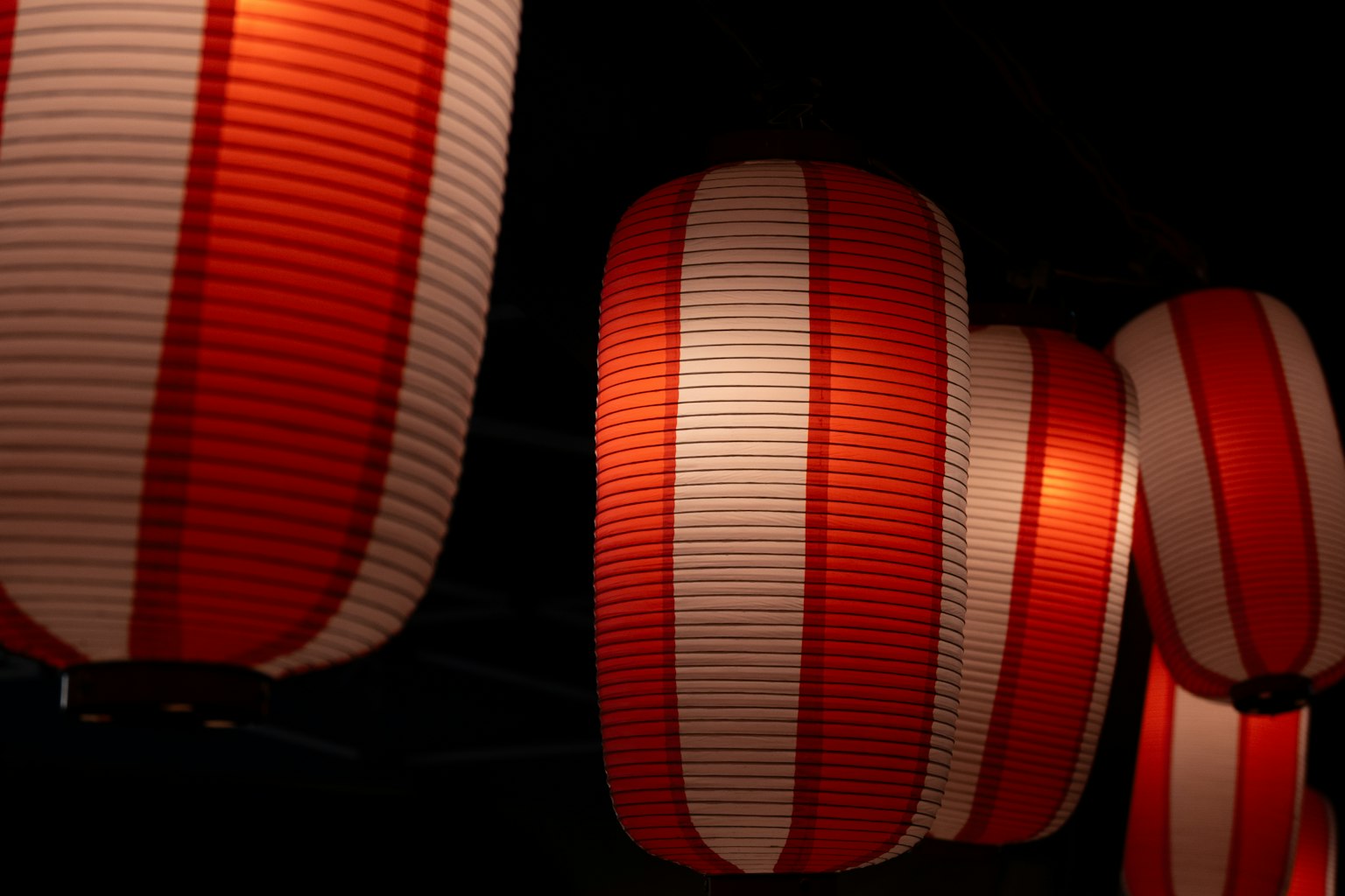 Red and white lanterns glowing against a dark background
