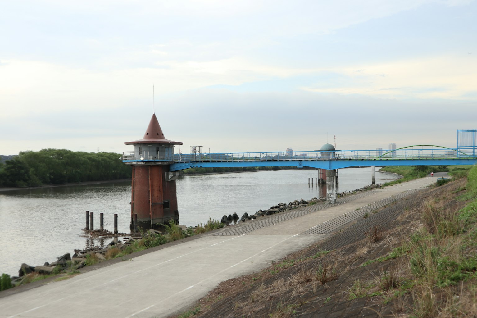 Malersicher Blick mit einem roten Turm und einer blauen Brücke am Fluss