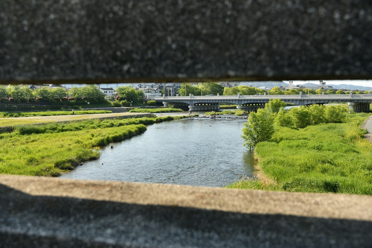 View of a river and bridge framed by a stone structure