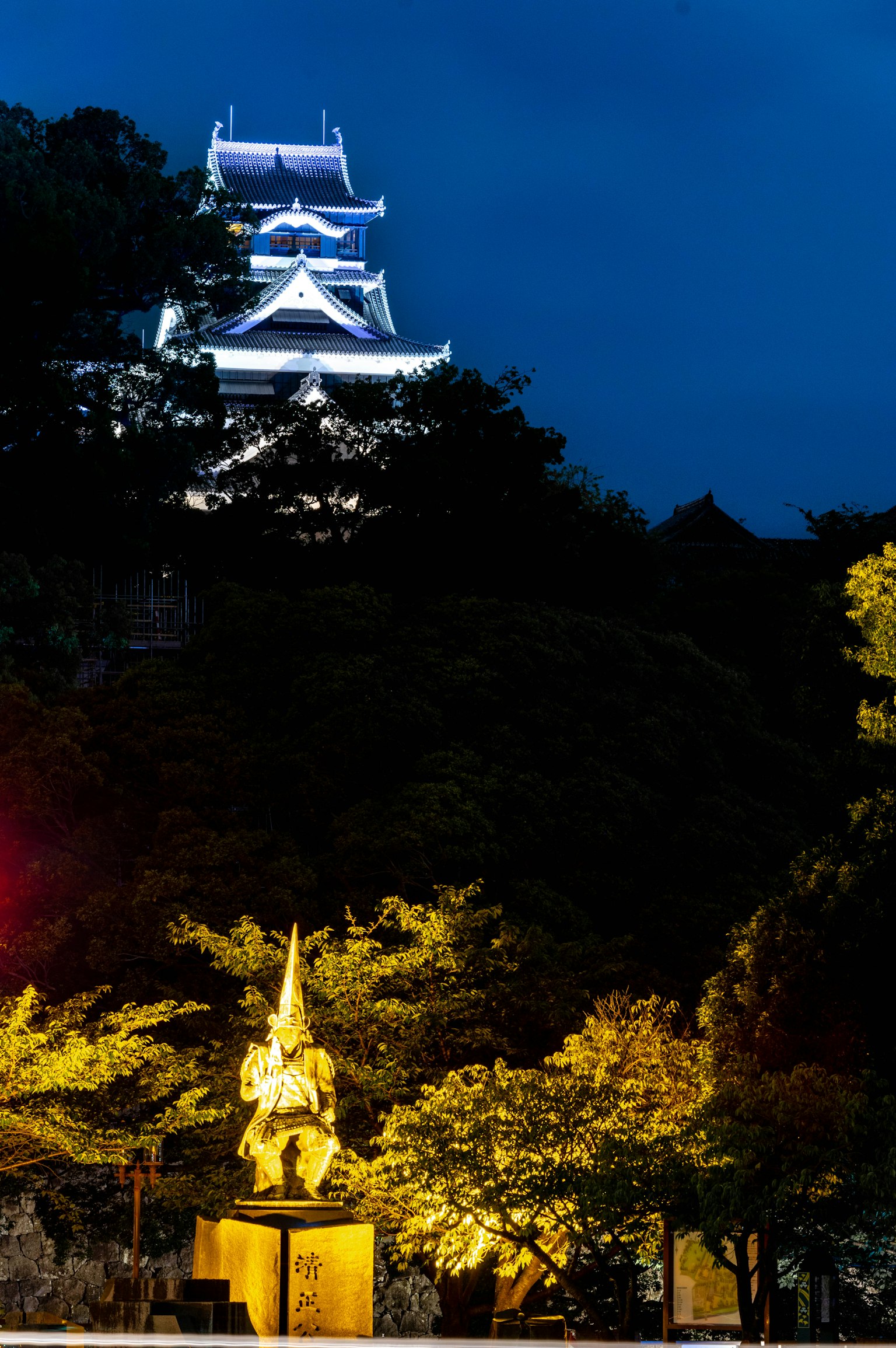 Beautiful night scene featuring a castle and a golden statue