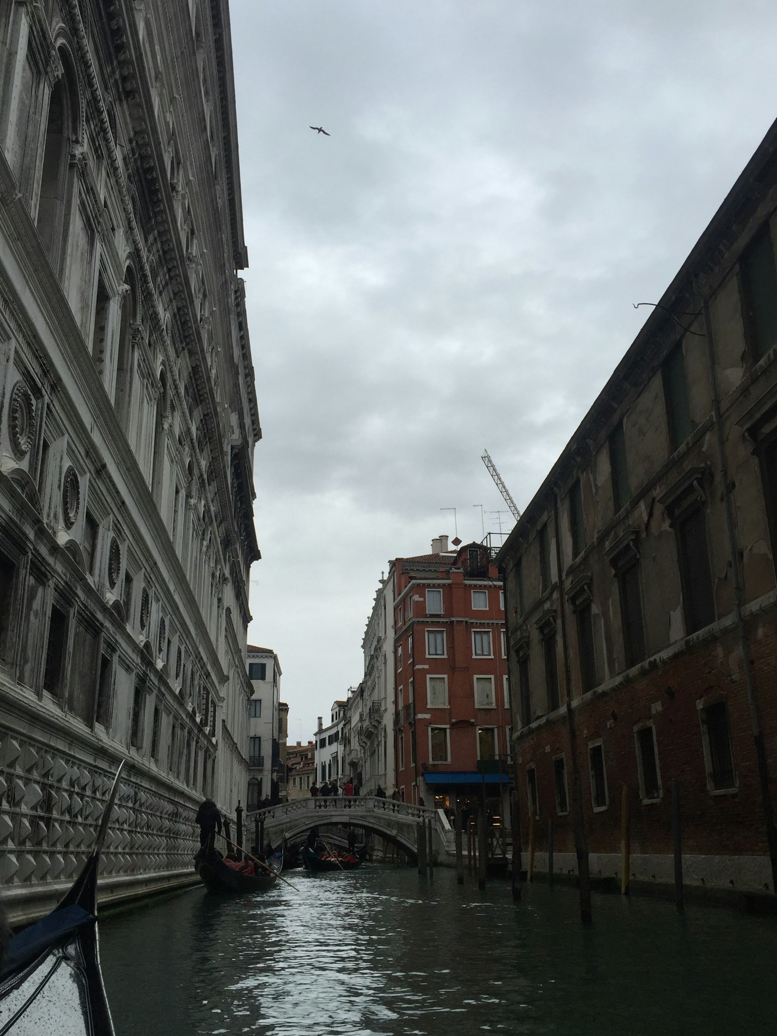 Photo of old buildings along a canal with a gray sky