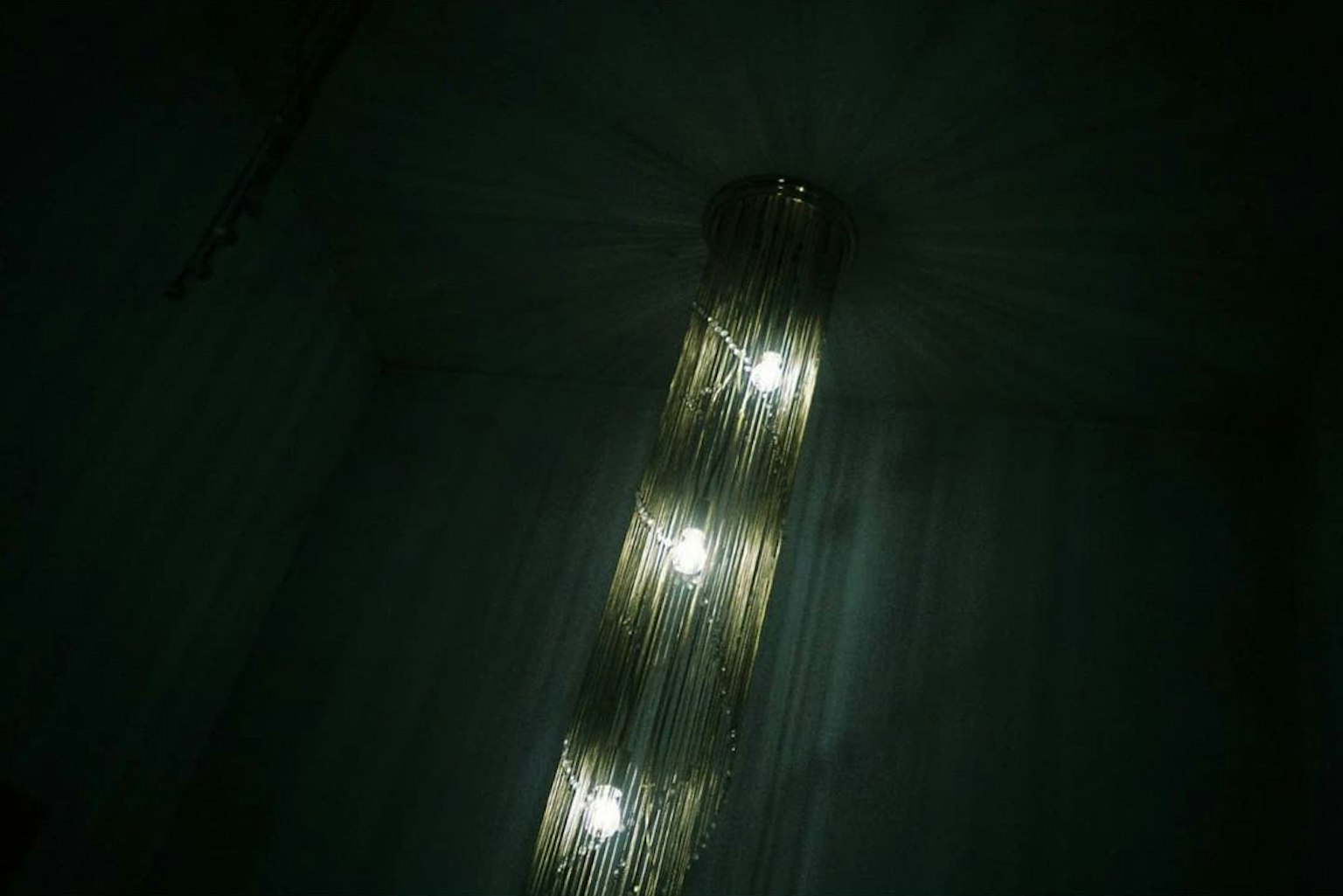 Chandelier lights hanging in a dark room