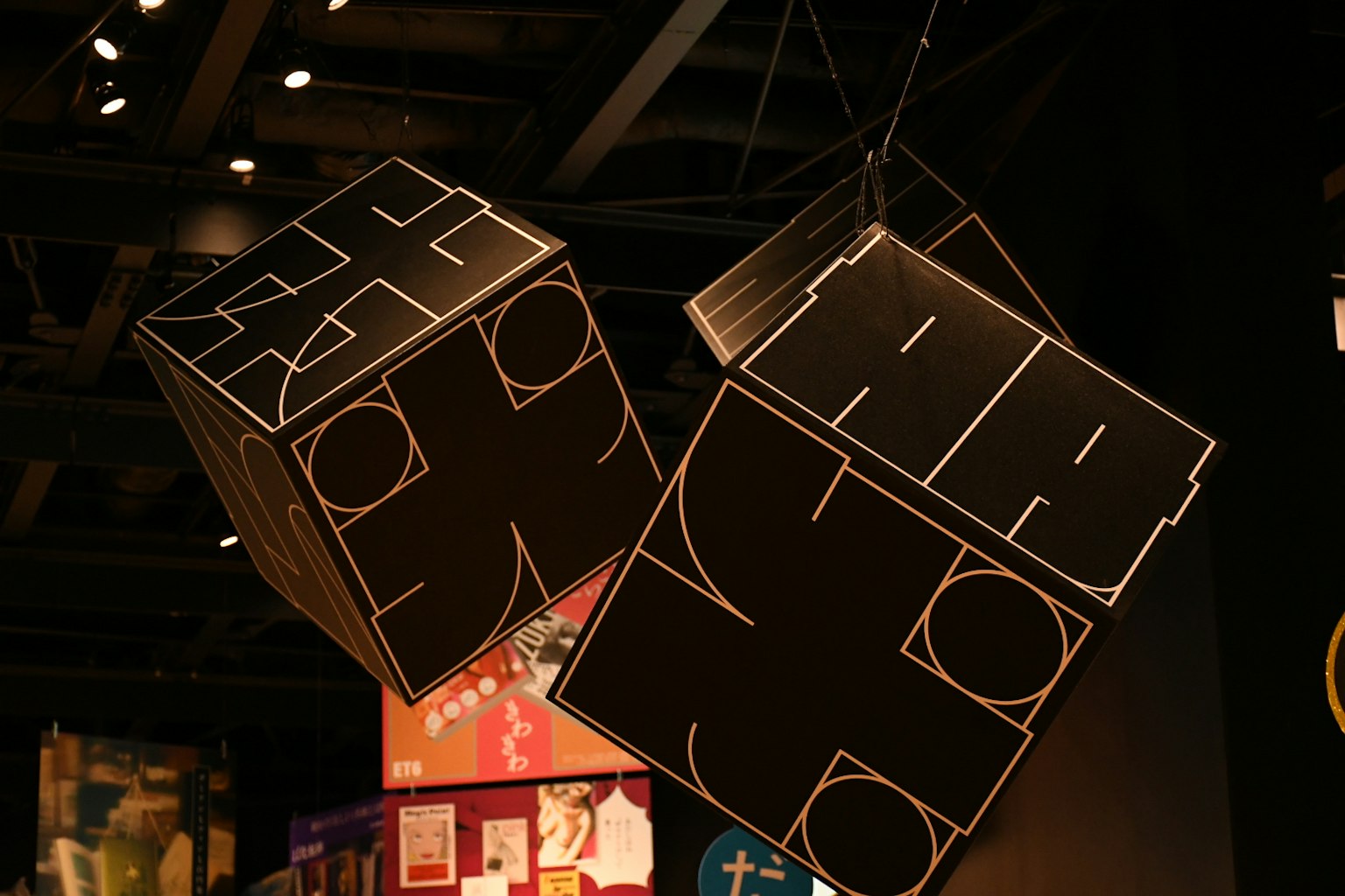 Hanging black cube sculptures with minimalist design in an exhibition