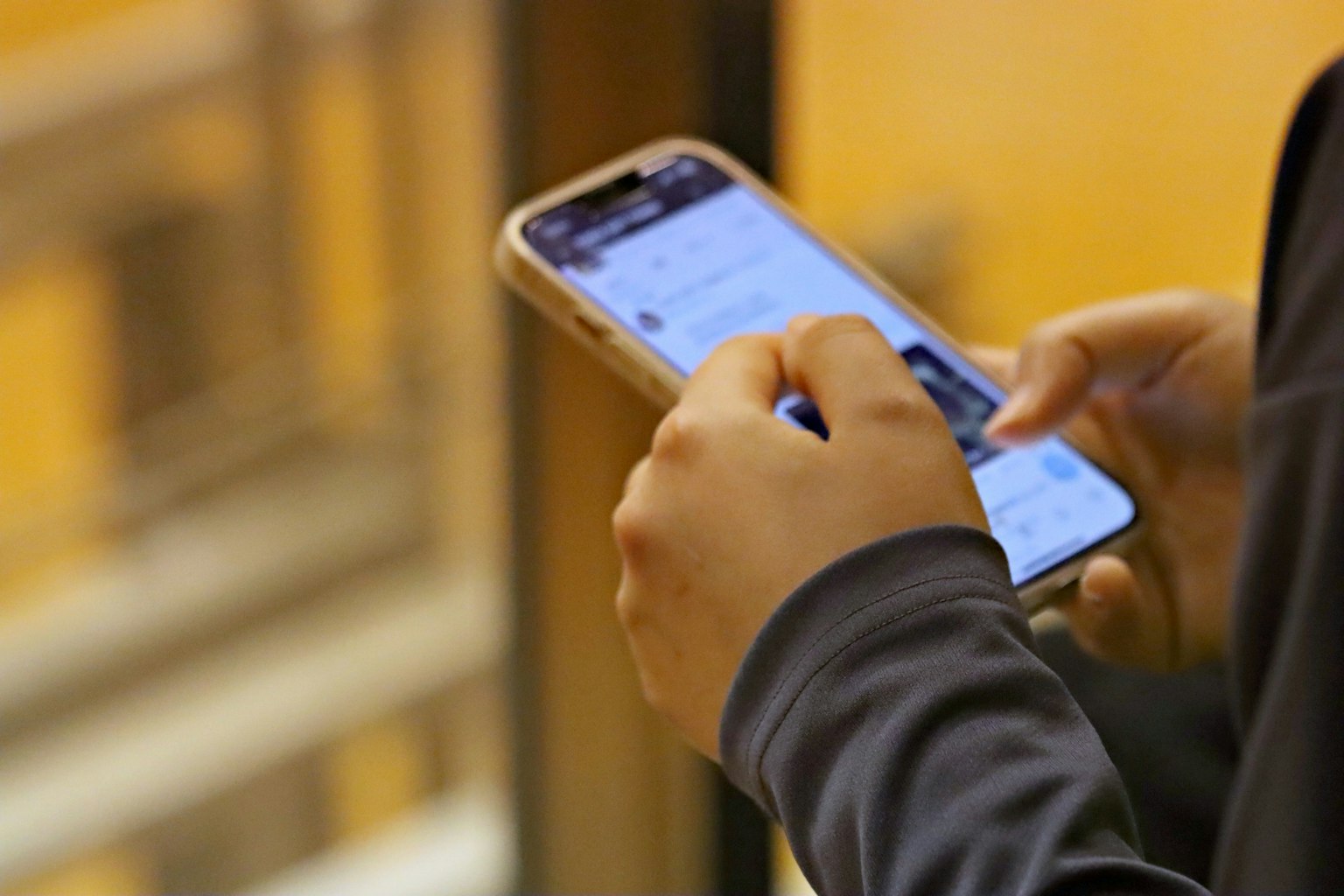 Close-up image of a person holding a smartphone