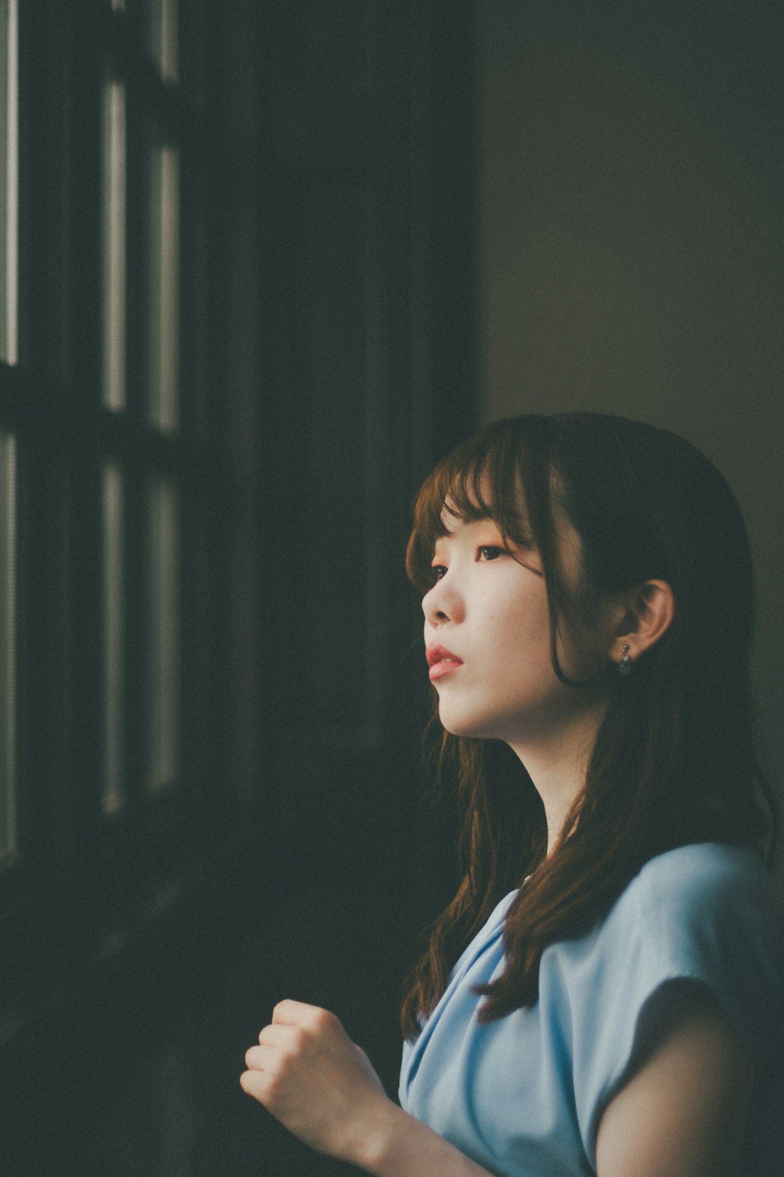 Portrait of a young woman gazing out the window
