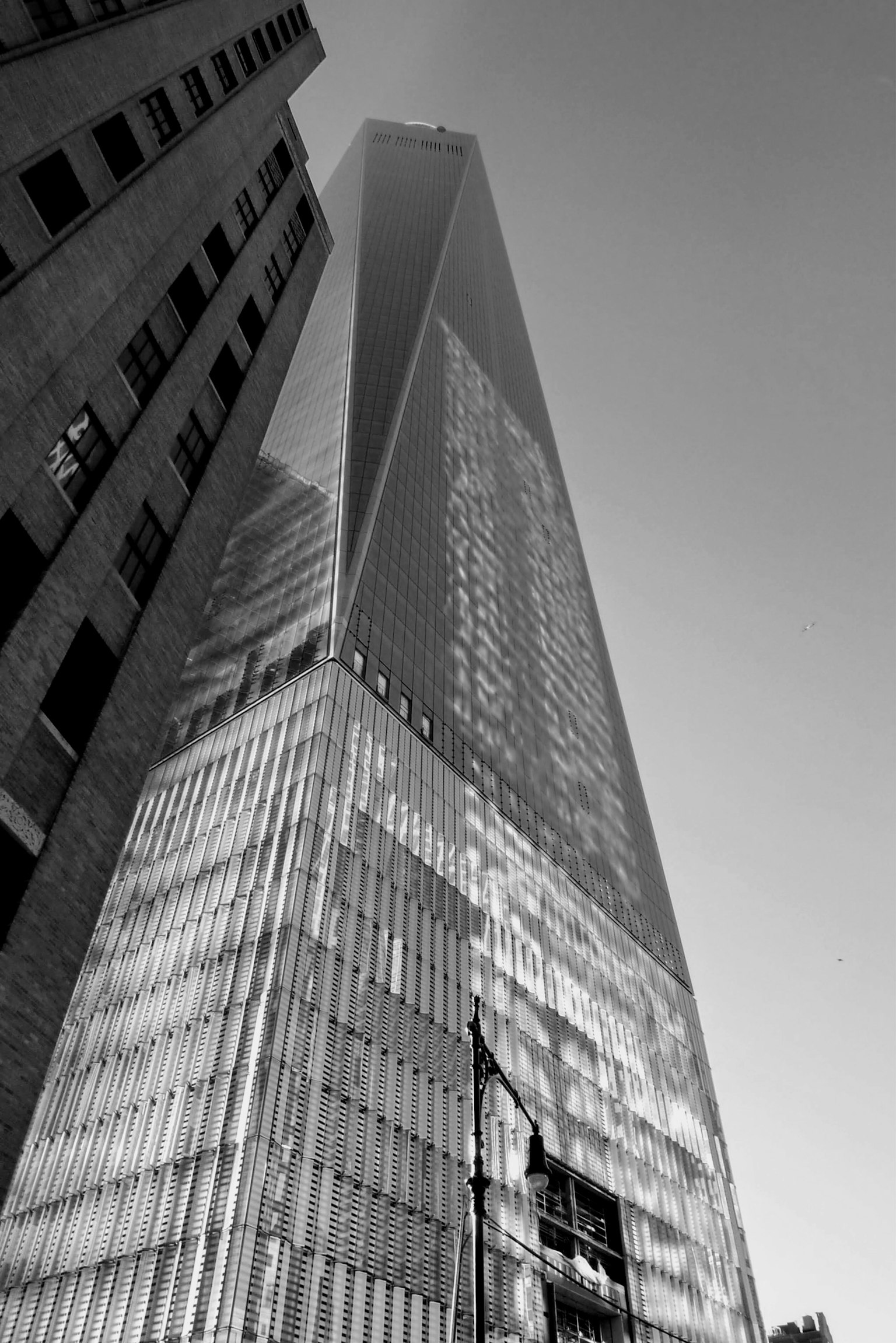 Photo d'un gratte-ciel vue en contre-plongée avec une façade en verre réfléchissant