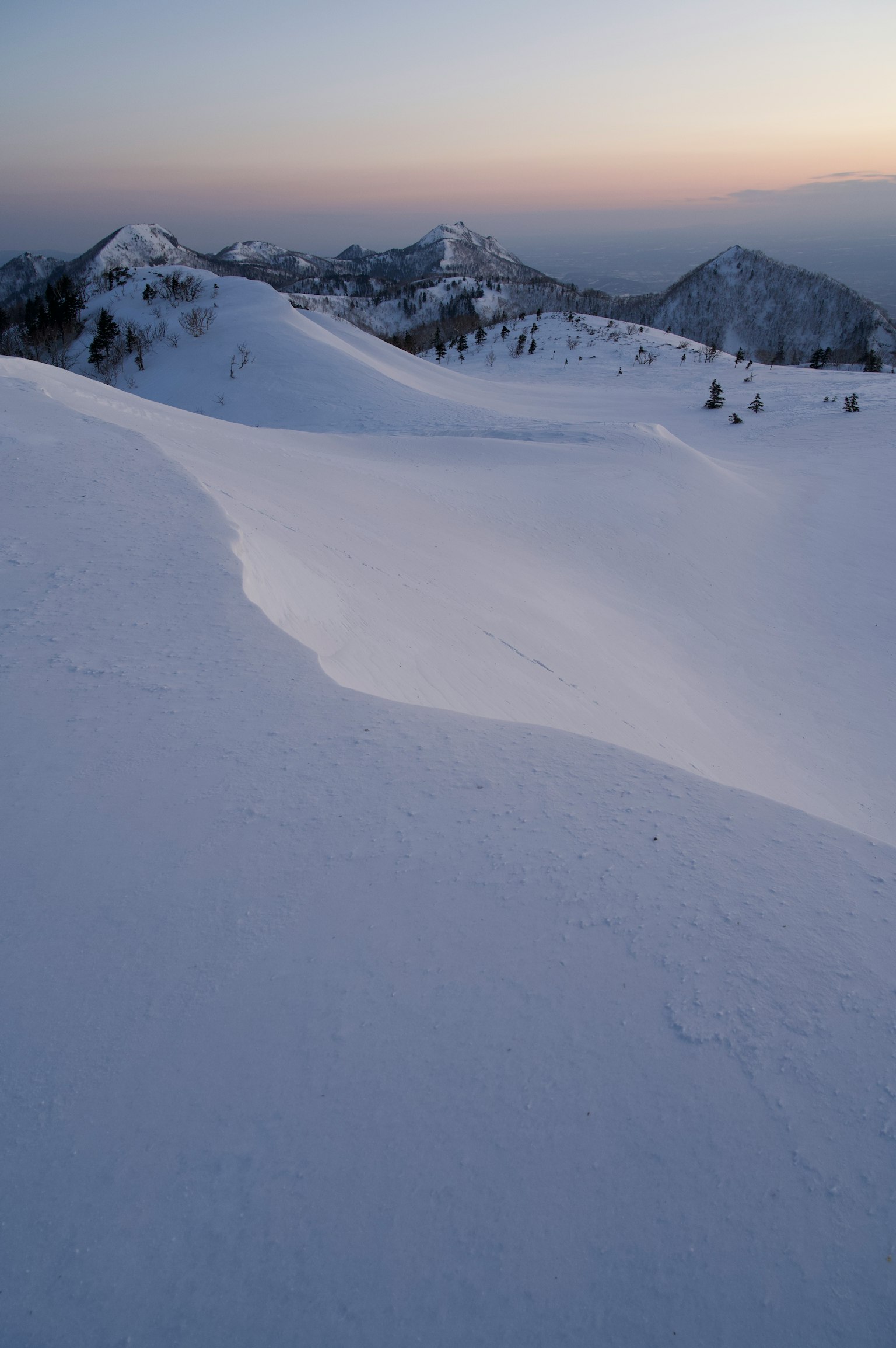 雪覆蓋的山景和柔和的日落色調
