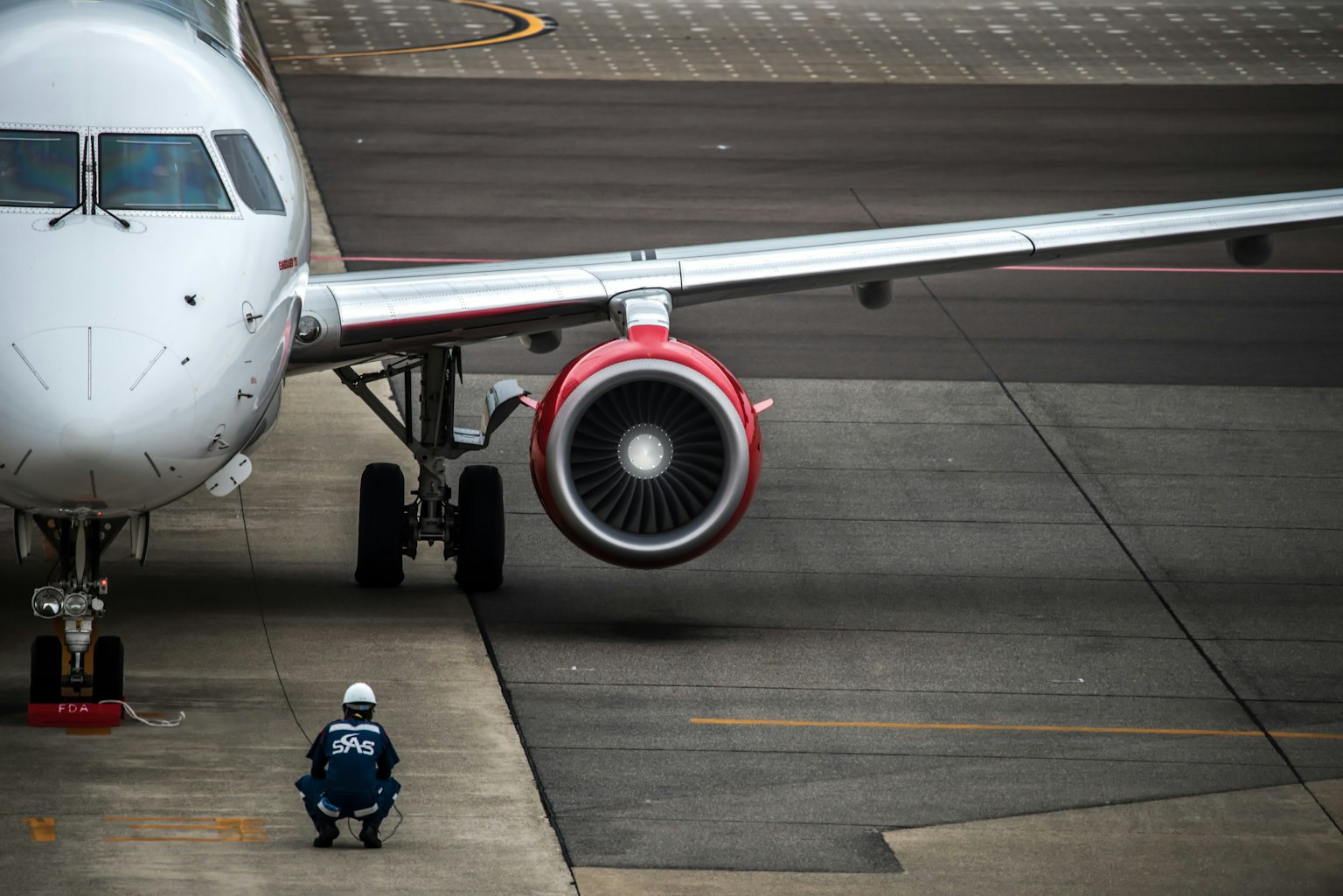 Ground staff sitting in front of an aircraft on the runway