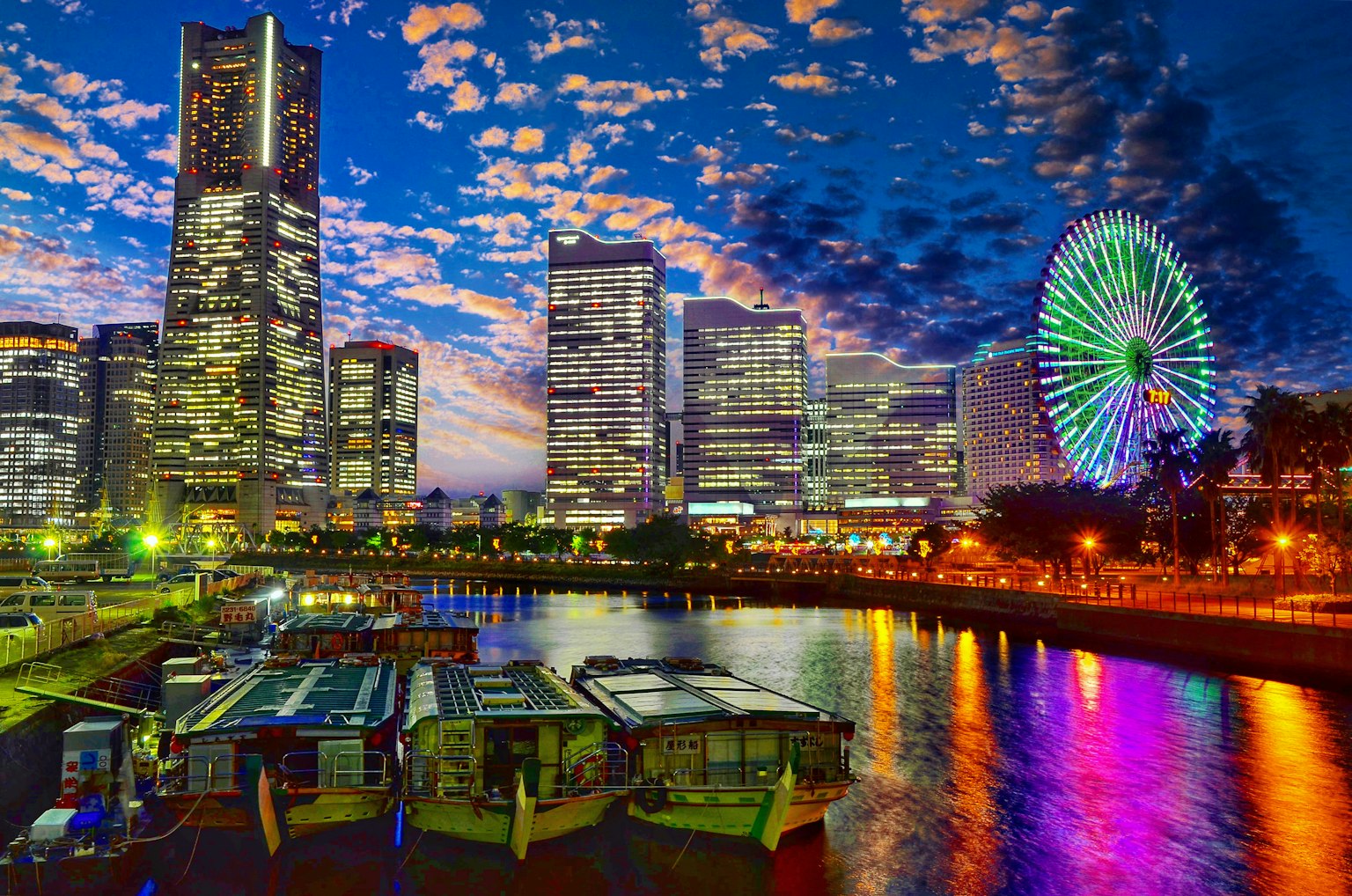 Yokohama skyline at night featuring skyscrapers and a Ferris wheel