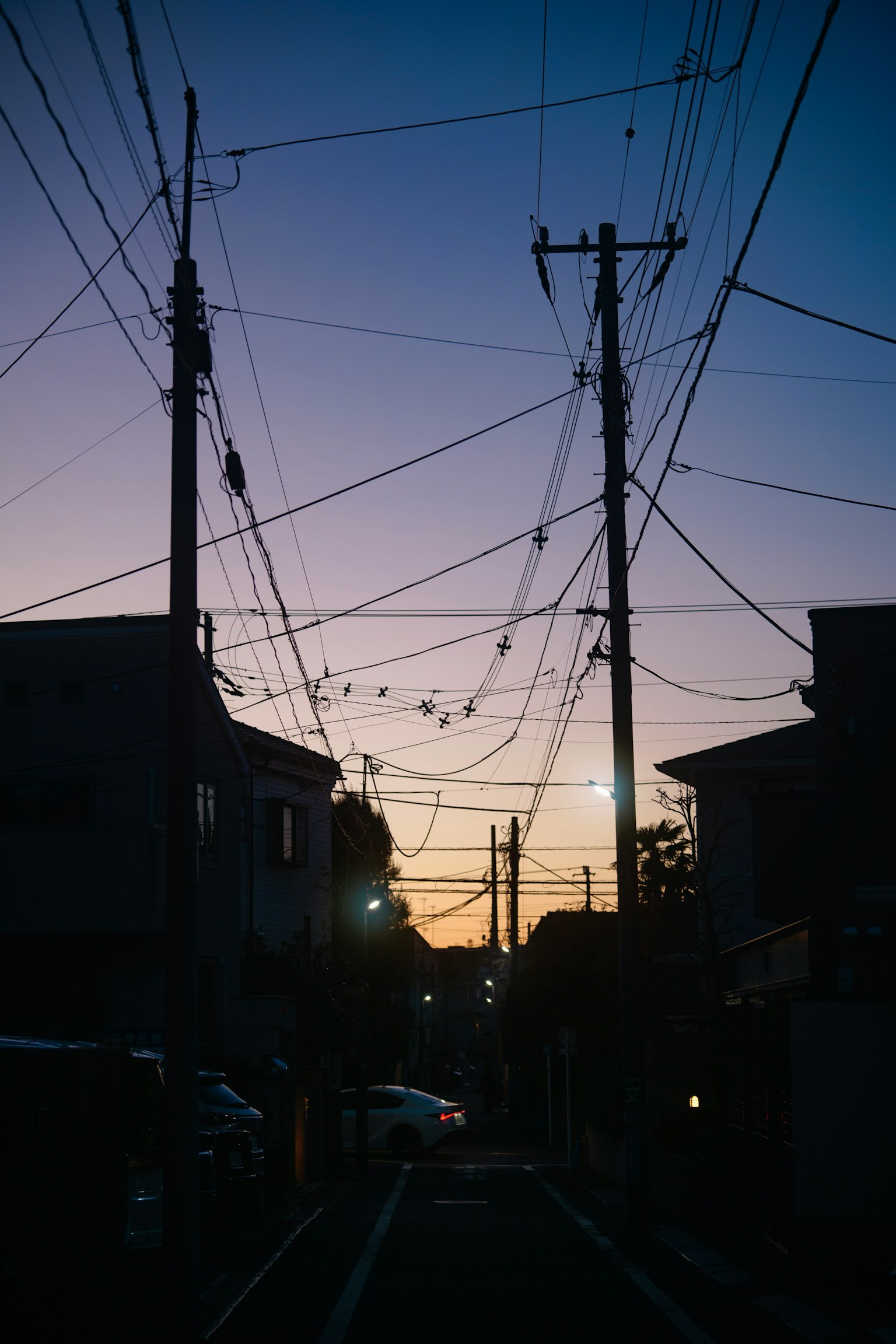 黃昏時分交錯電線的城市街道輪廓