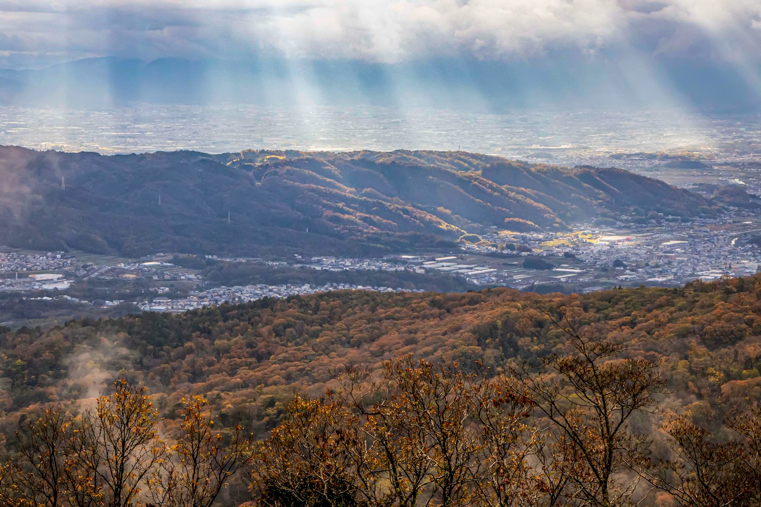 Mountain landscape with autumn foliage and distant hills
