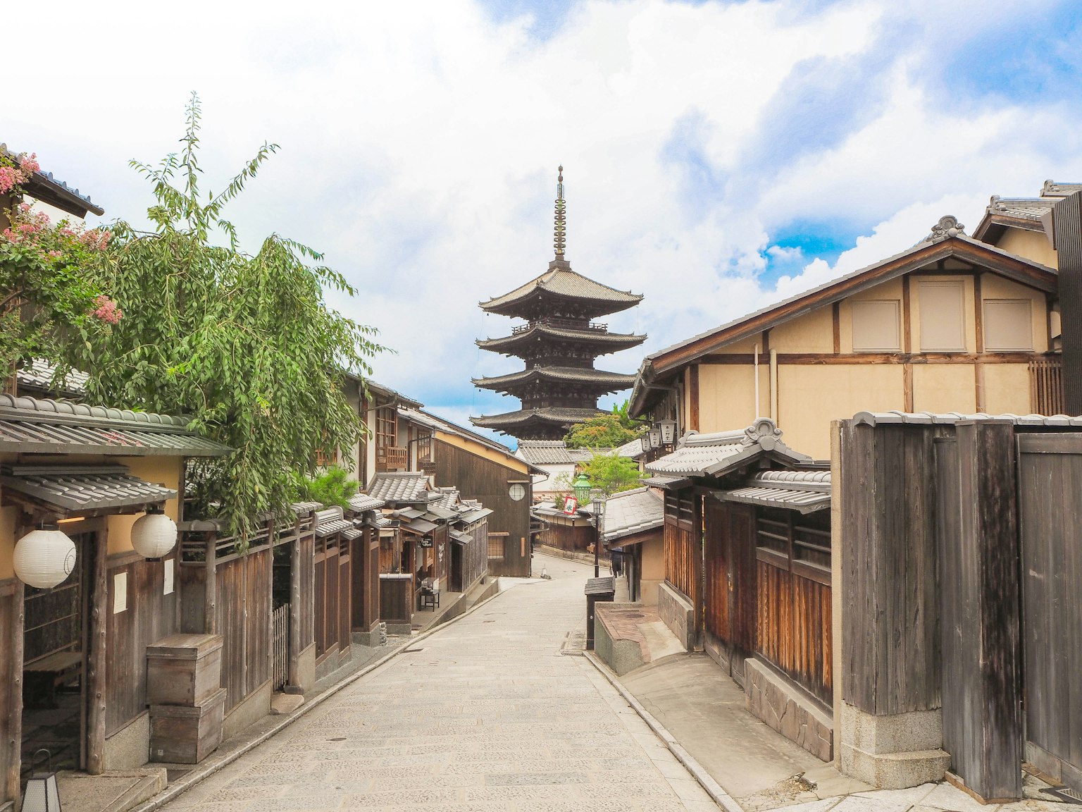 Scenic view of a traditional Japanese street featuring a pagoda and wooden buildings