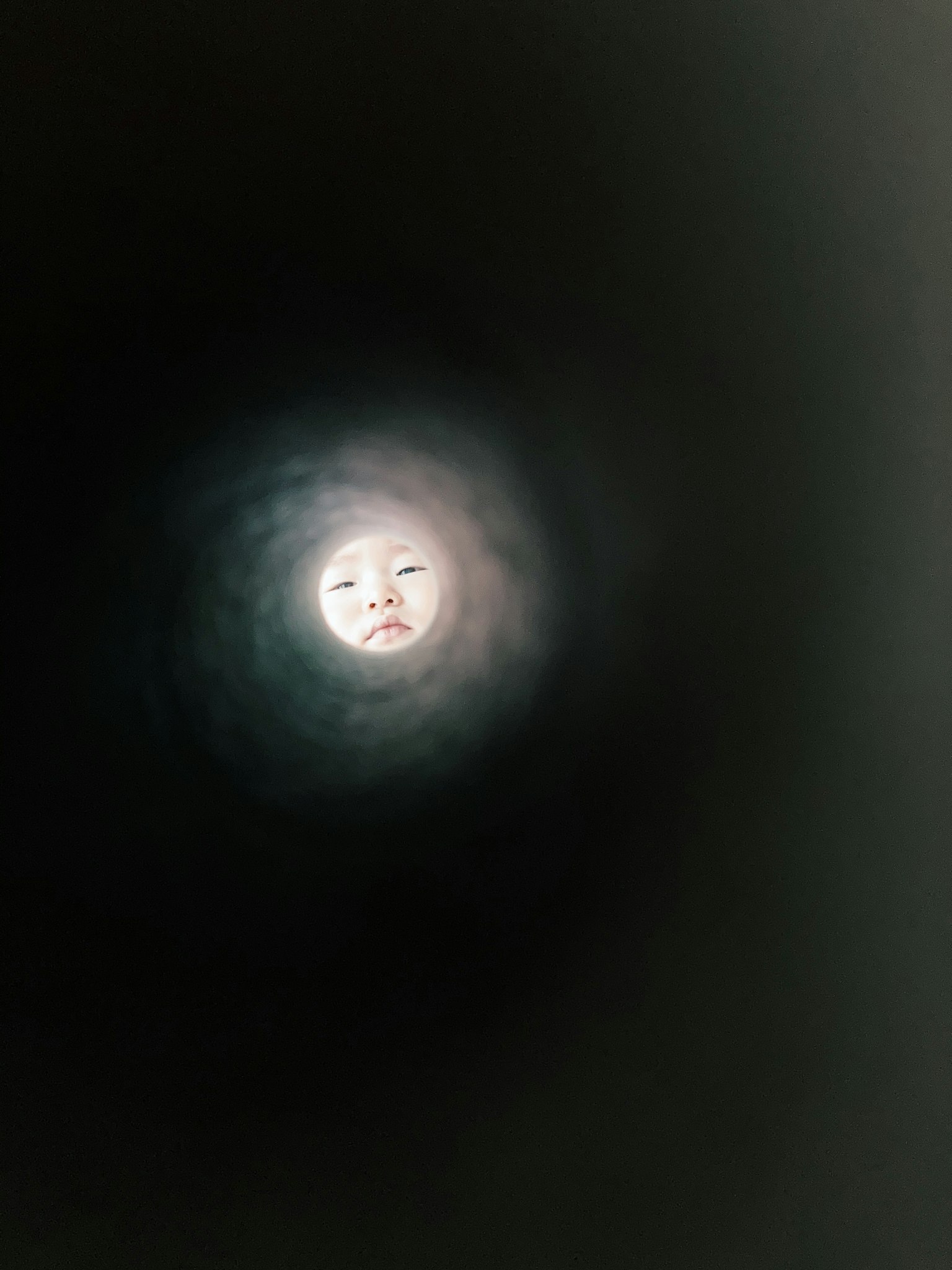 Image of a moon with a face appearing in a dark background