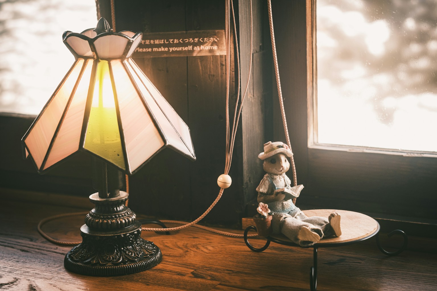 Still life of a lamp and doll on a table