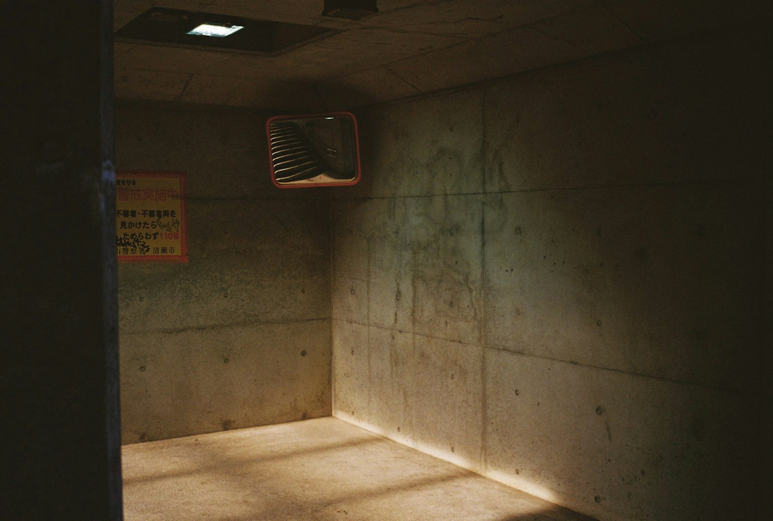 コンクリートの壁と薄暗い照明のある部屋の内部