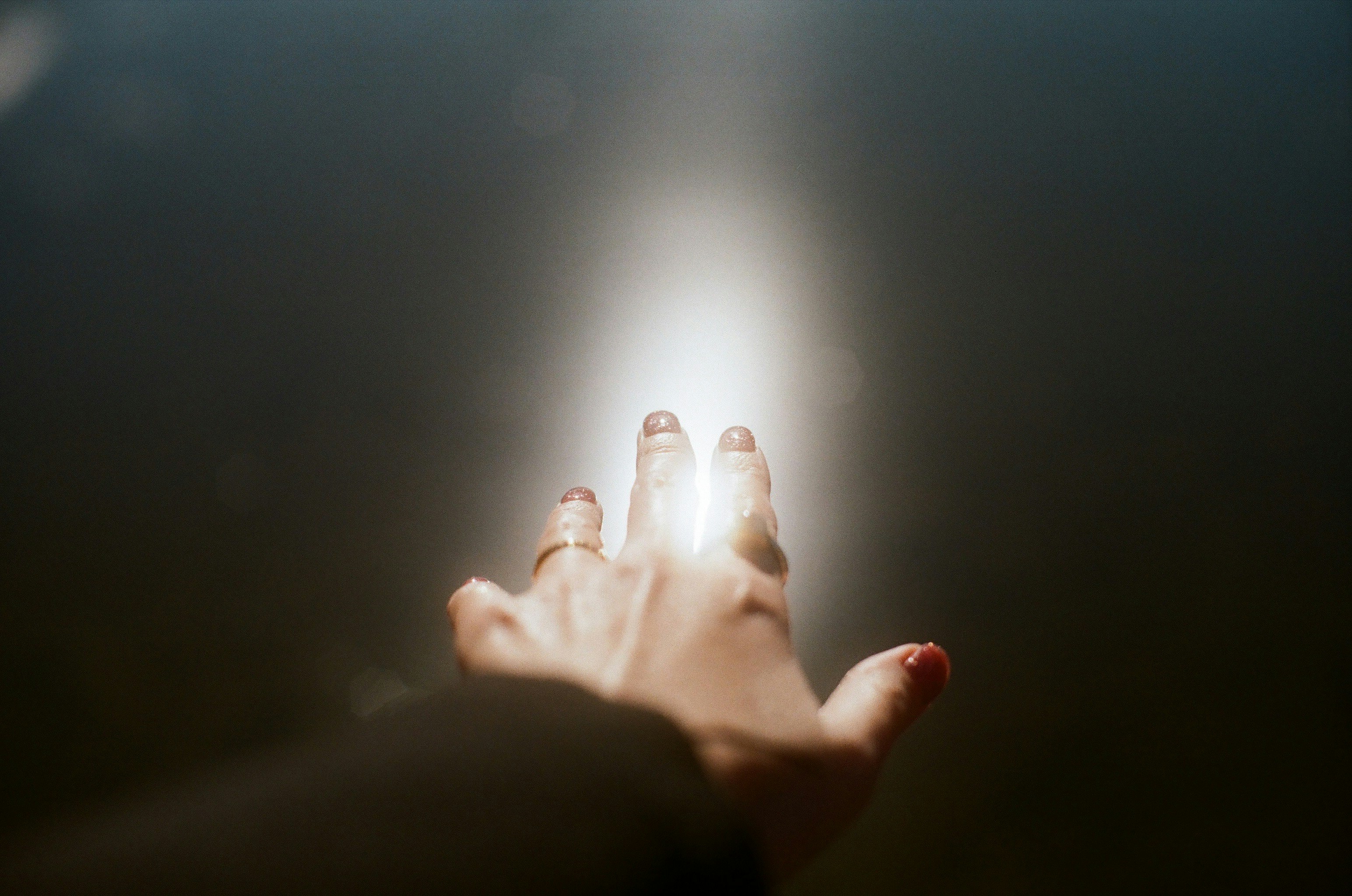 film photography of hands reaching forward
