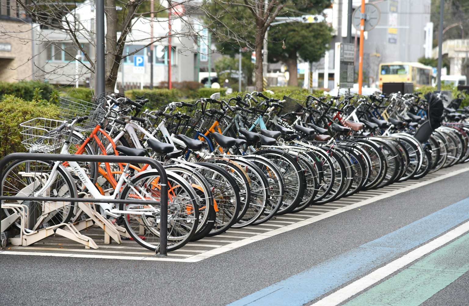 A row of bicycles parked in a bike rack