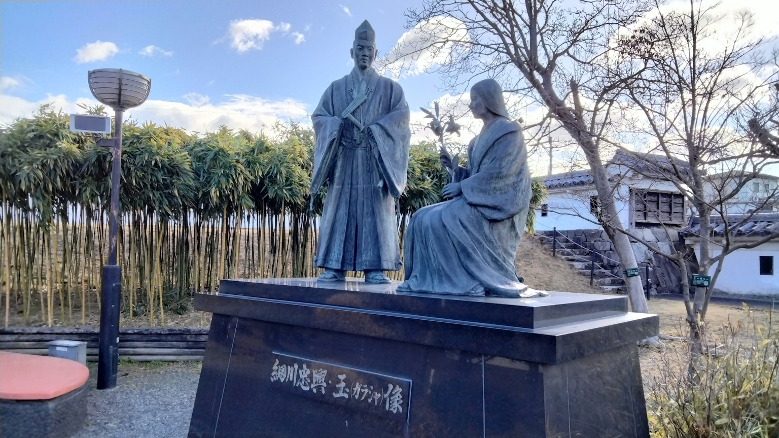 Bronze statue depicting two figures in a park setting