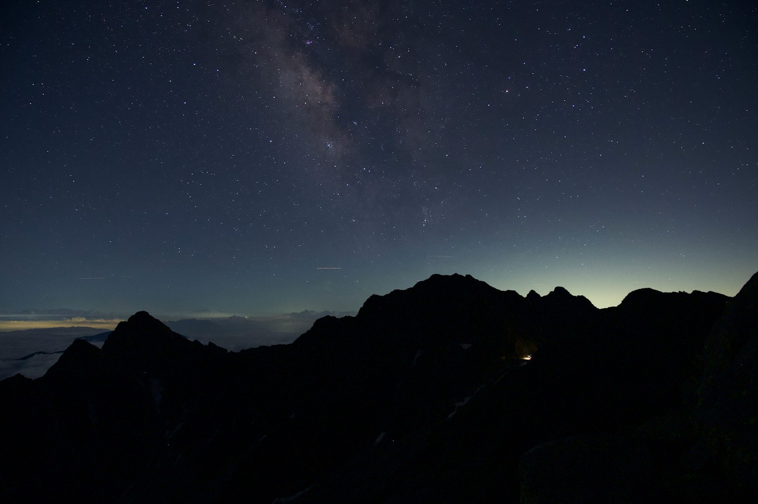 Starry night sky with mountain silhouette