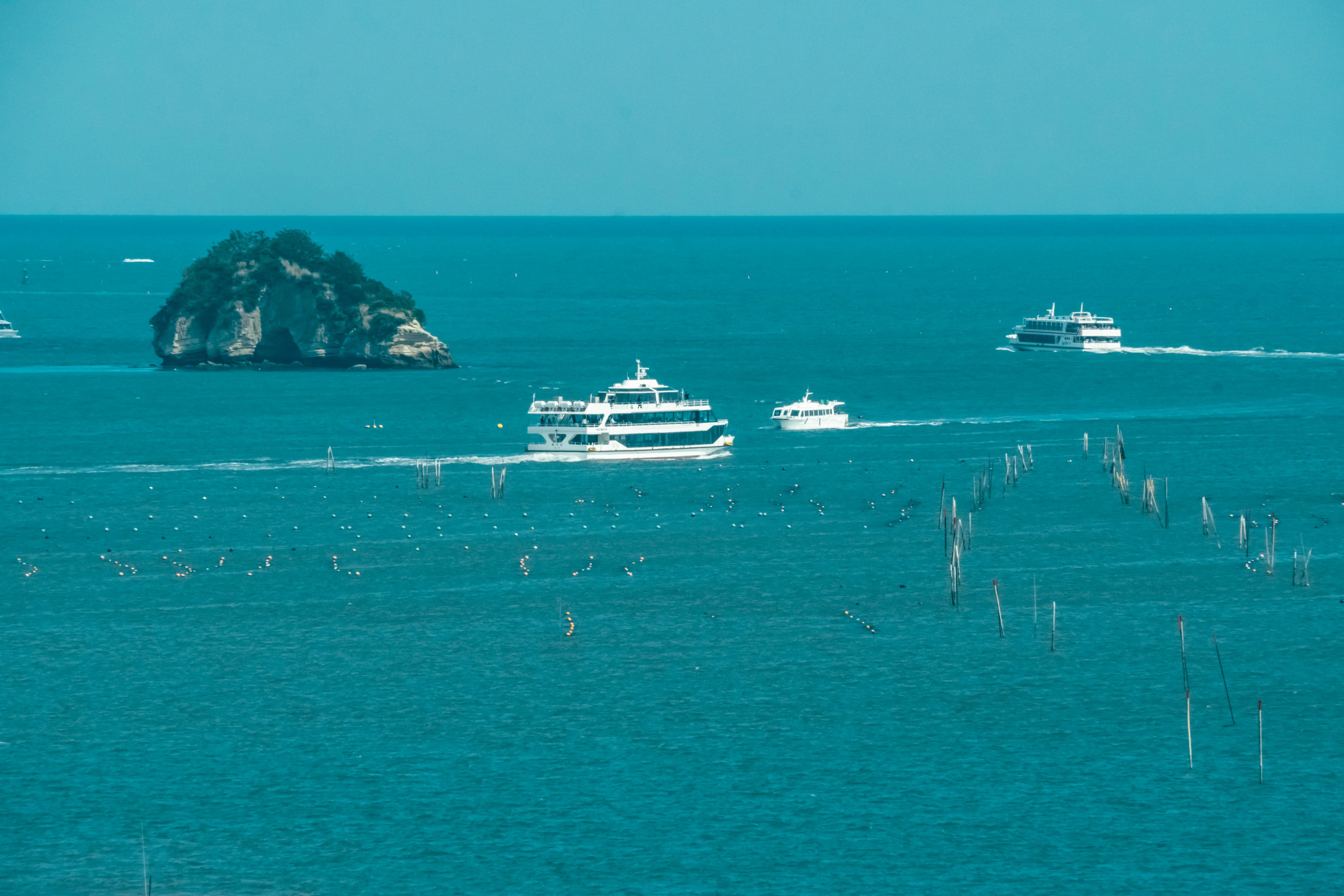 海上を行くフェリーと遠くの島の景色