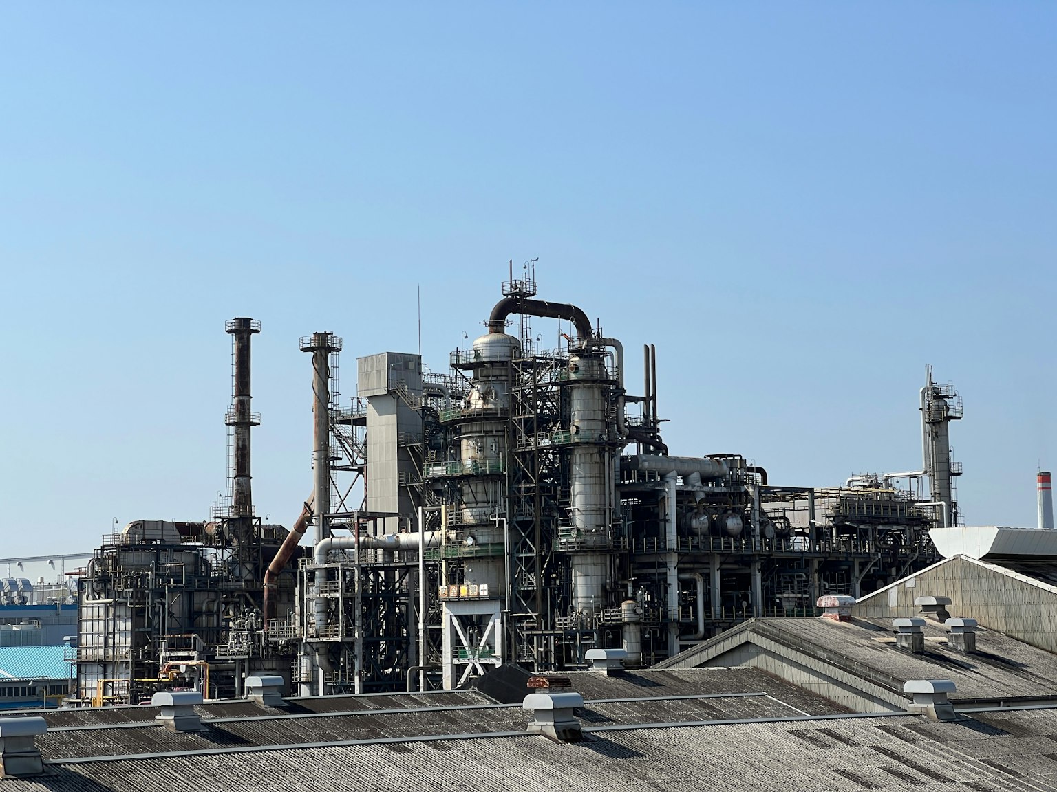 Industrial plant structure under clear blue sky