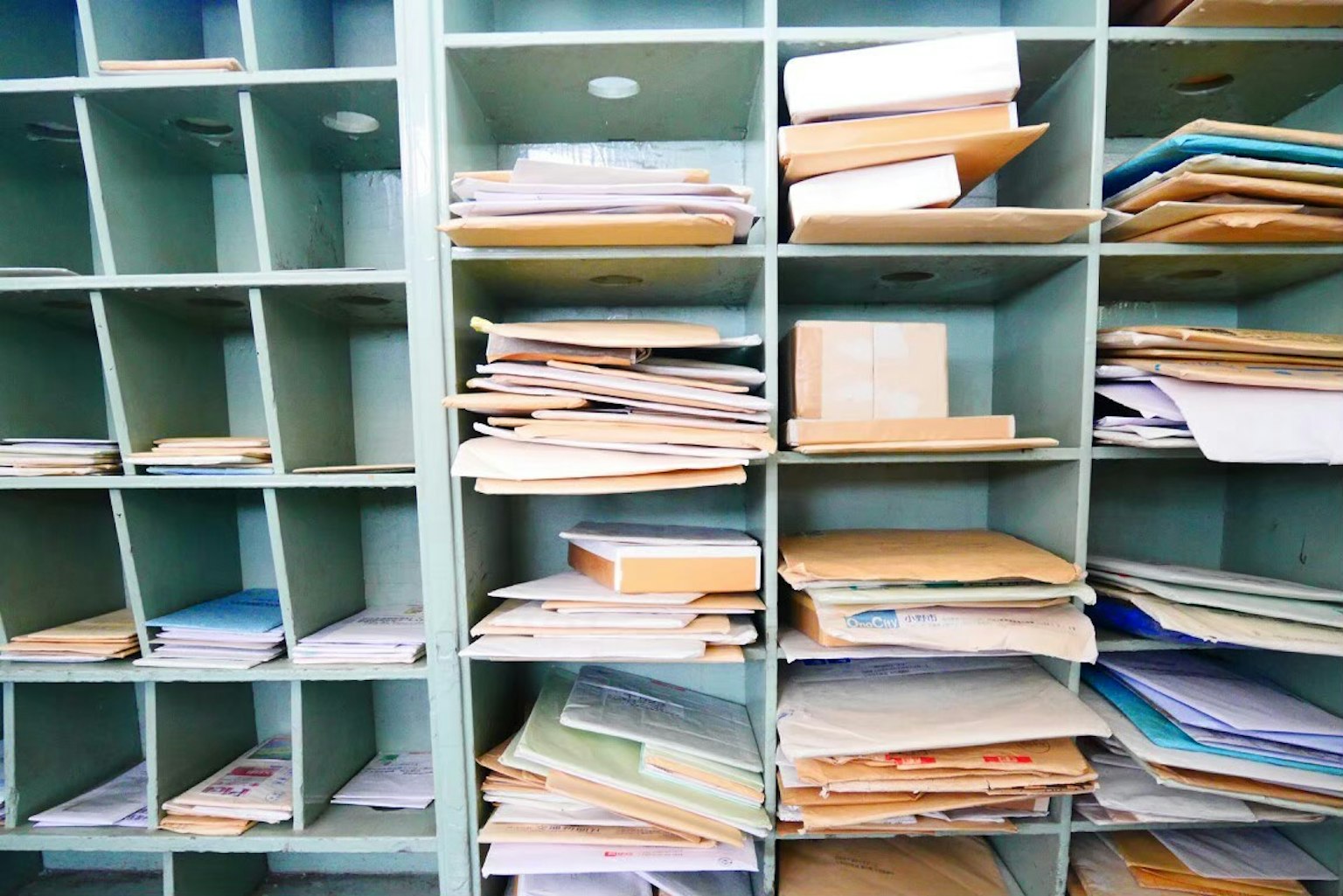 Image of a storage shelf filled with disorganized papers