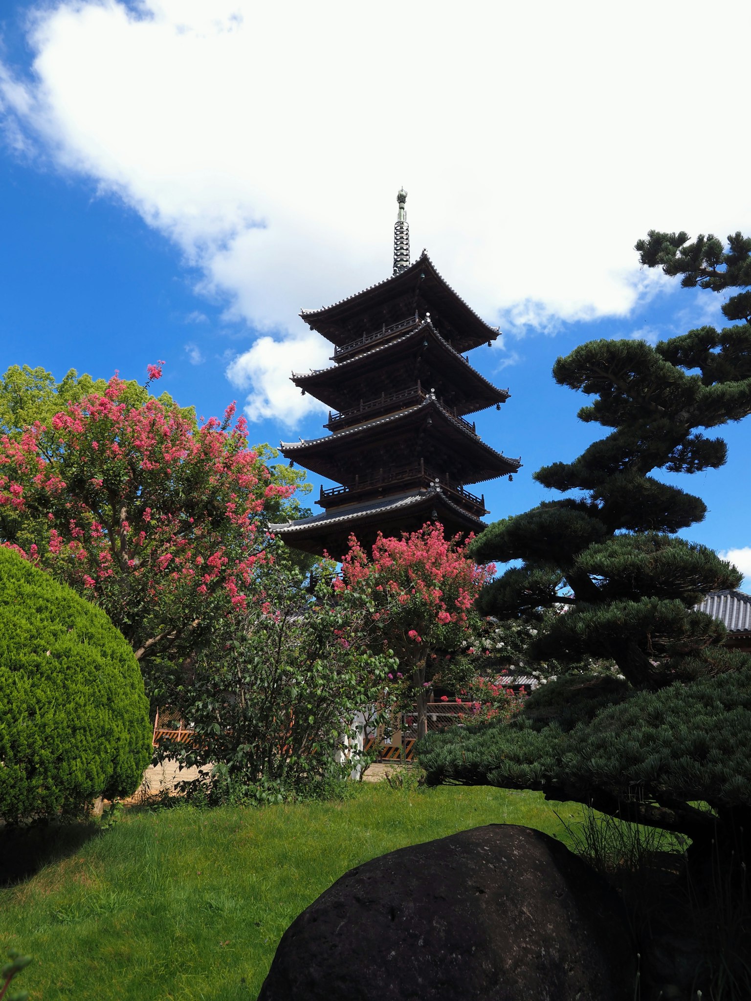 Beautiful Japanese garden featuring a five-story pagoda and colorful flowers