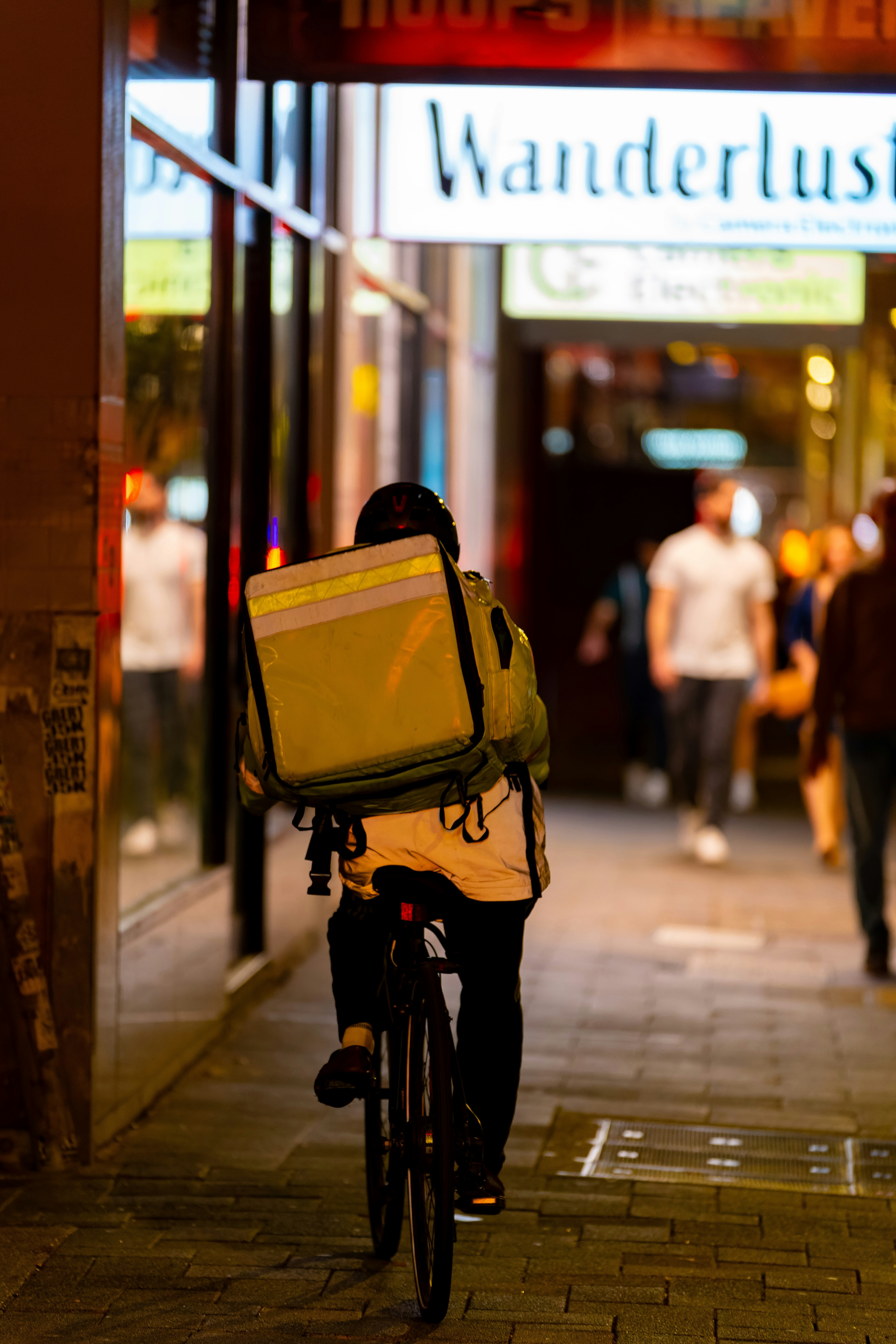 person riding a bicycle on a nighttime street